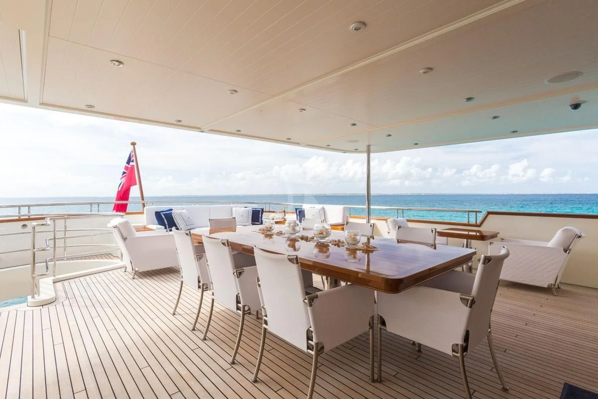 a room with tables and chairs aboard FABULOUS CHARACTER Yacht for Charter