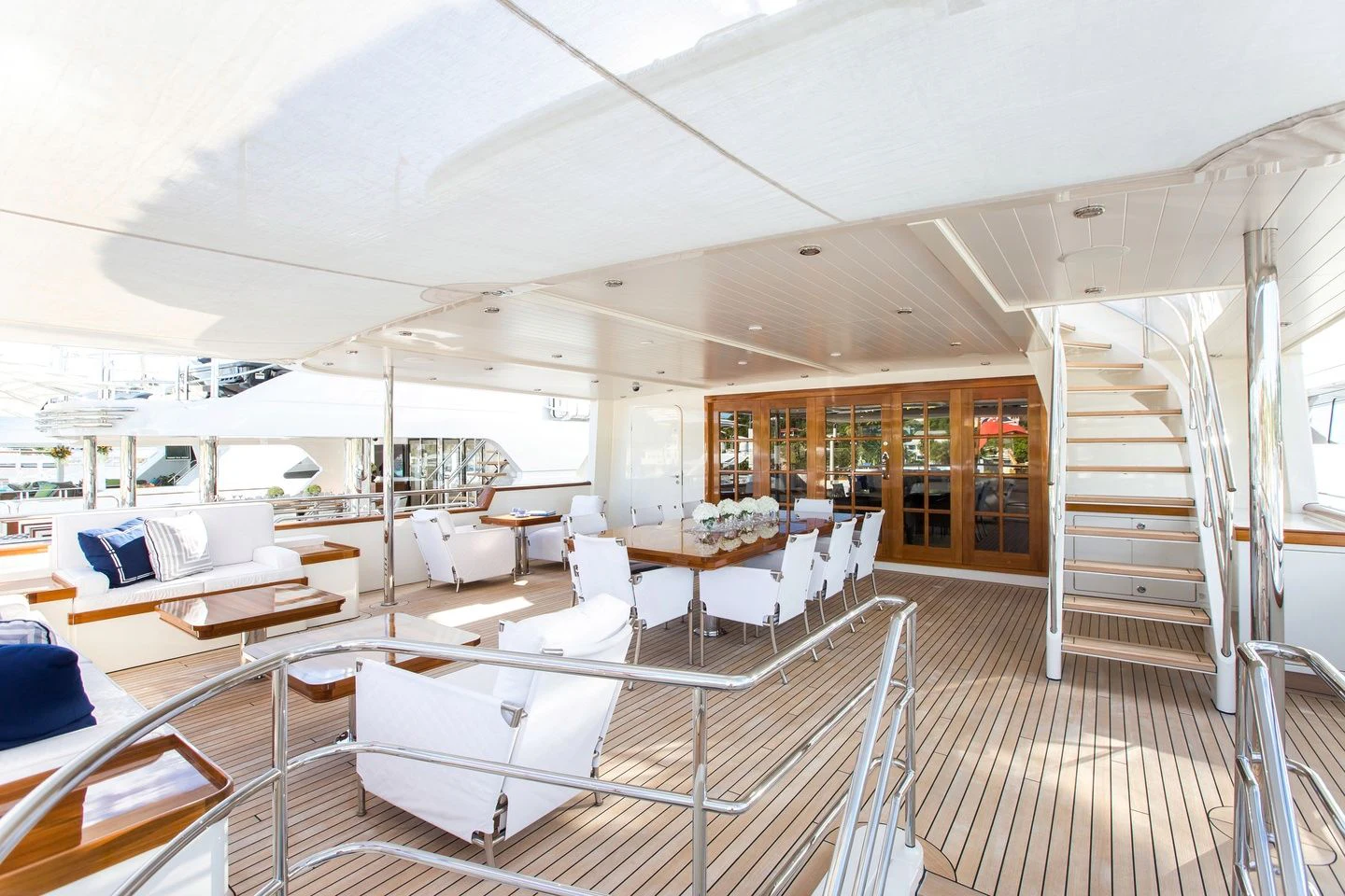 a large room with white furniture aboard FABULOUS CHARACTER Yacht for Charter