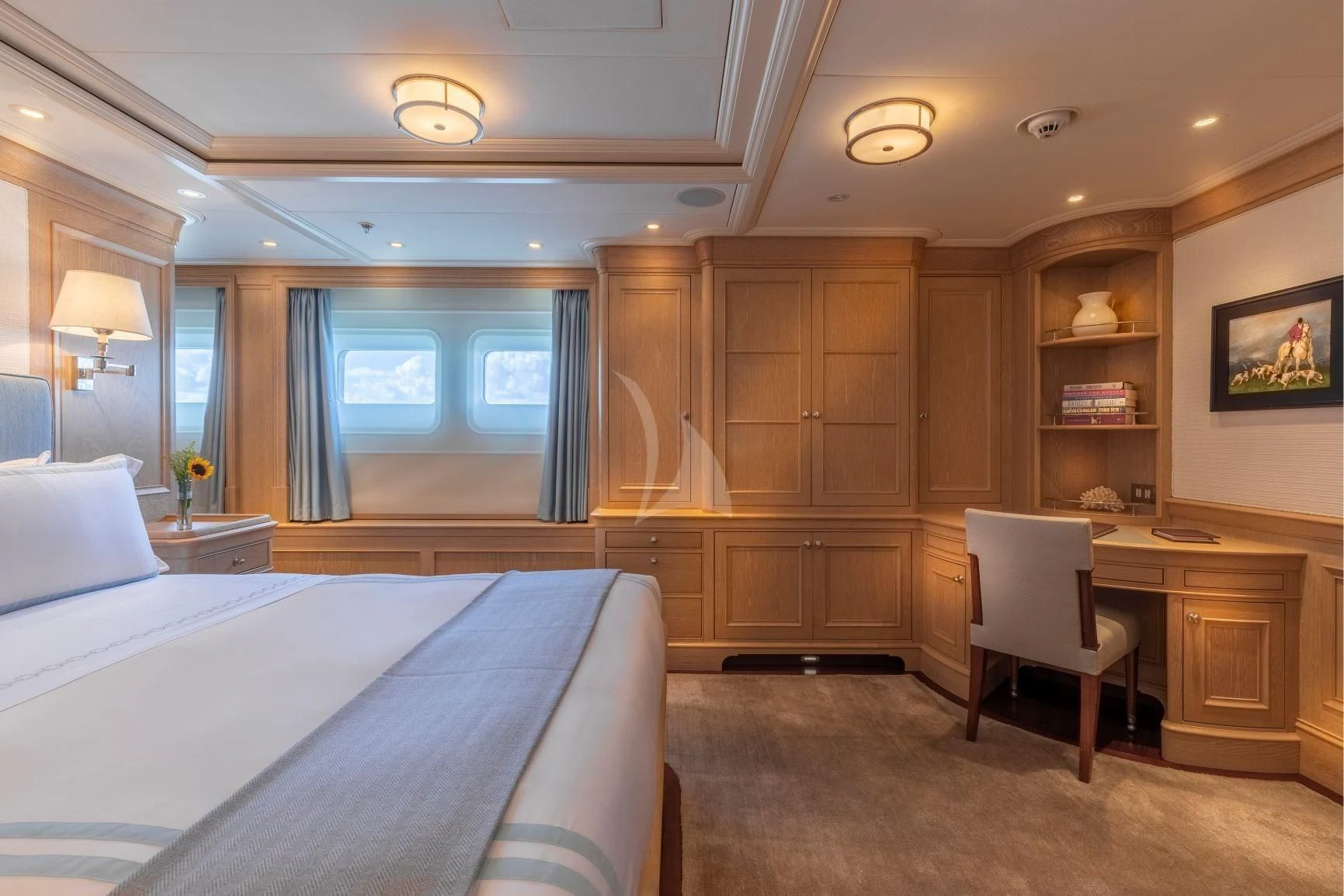 a bedroom with a bed and desk aboard FABULOUS CHARACTER Yacht for Charter