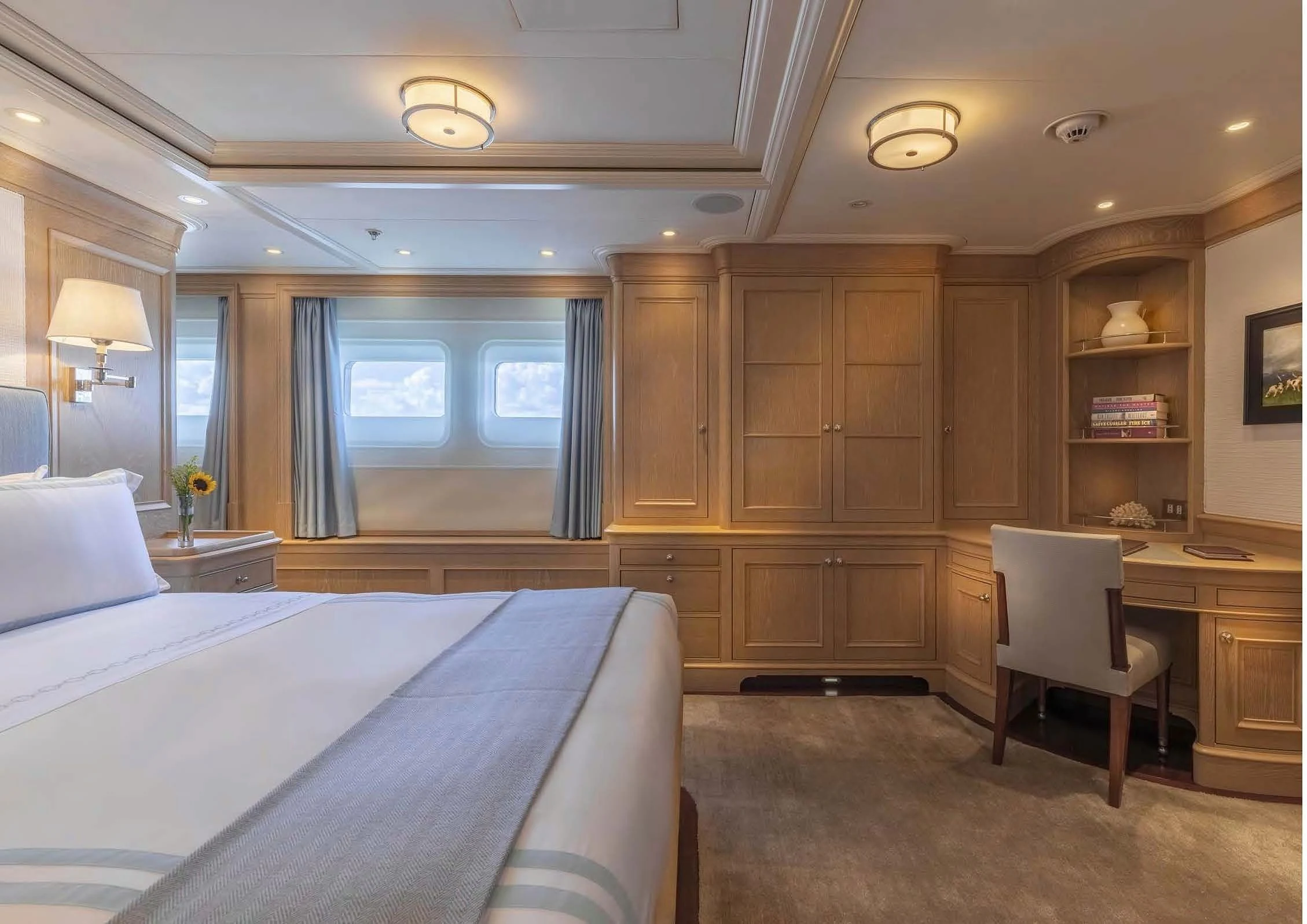a bedroom with a bed and a desk aboard FABULOUS CHARACTER Yacht for Charter
