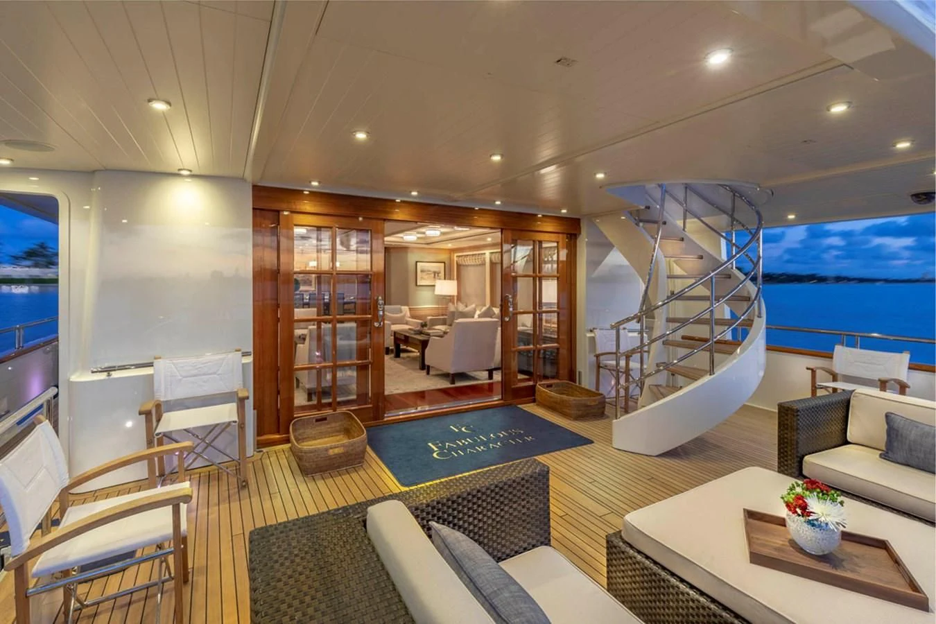 a living room with a large glass door and a large swimming pool aboard FABULOUS CHARACTER Yacht for Charter