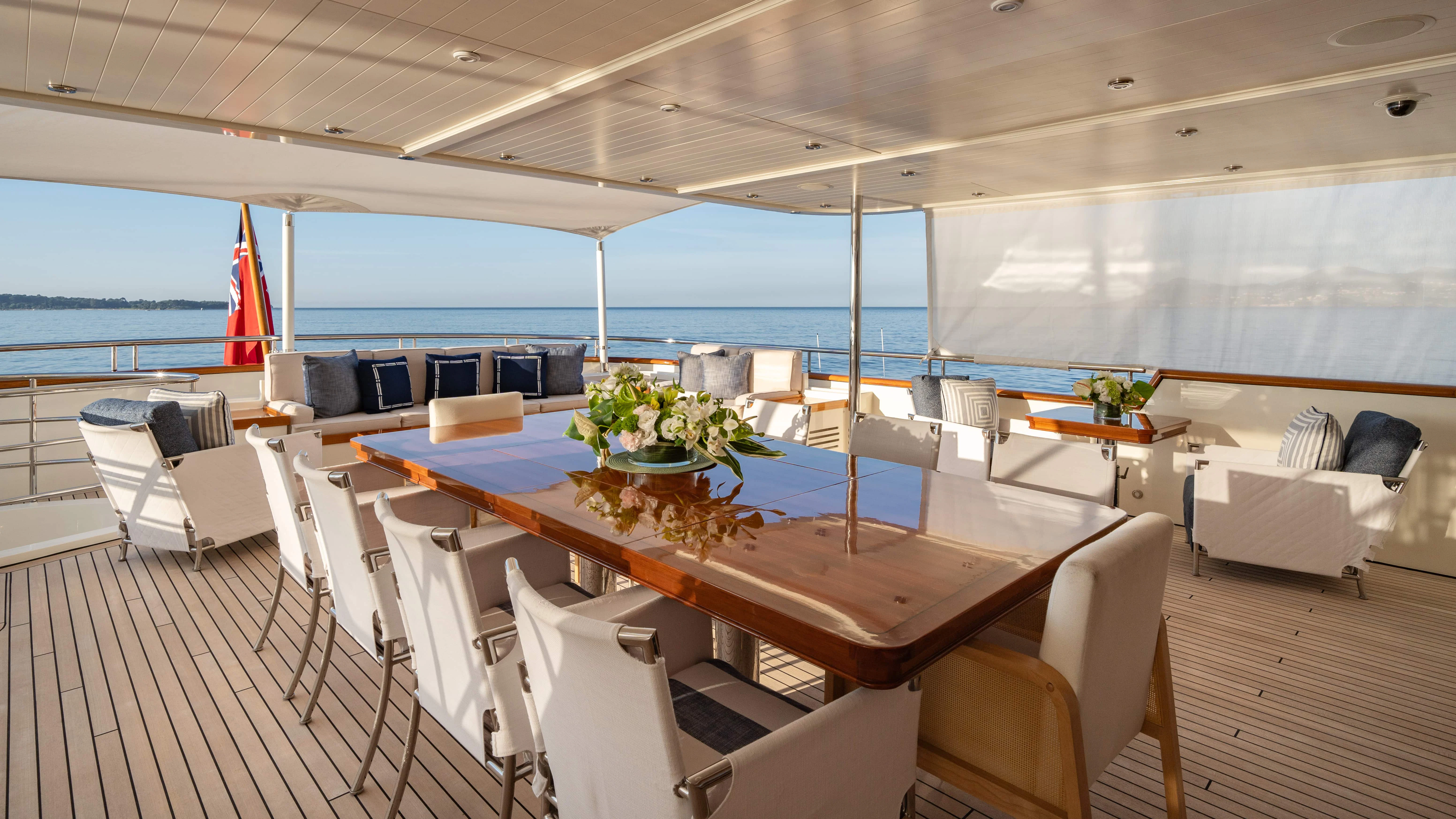 a room with a table and chairs aboard FABULOUS CHARACTER Yacht for Charter
