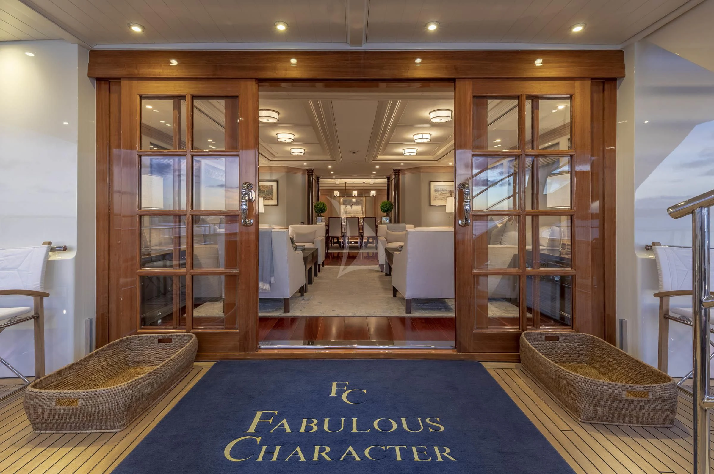a large room with a large glass door and a large blue rug aboard FABULOUS CHARACTER Yacht for Charter