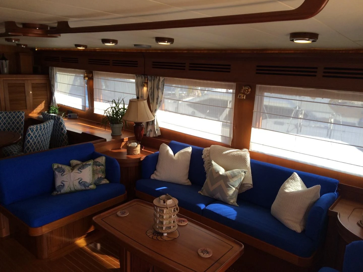 a living room with a blue couch and a coffee table aboard VK Yacht for Sale