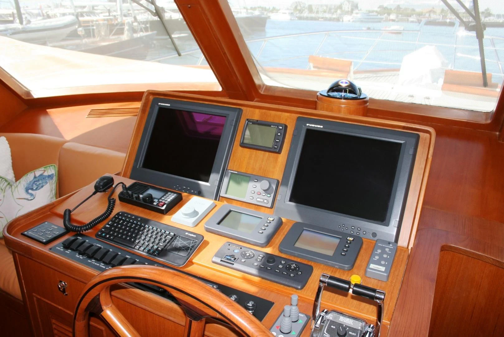 a desk with a computer and other electronics on it aboard VK Yacht for Sale