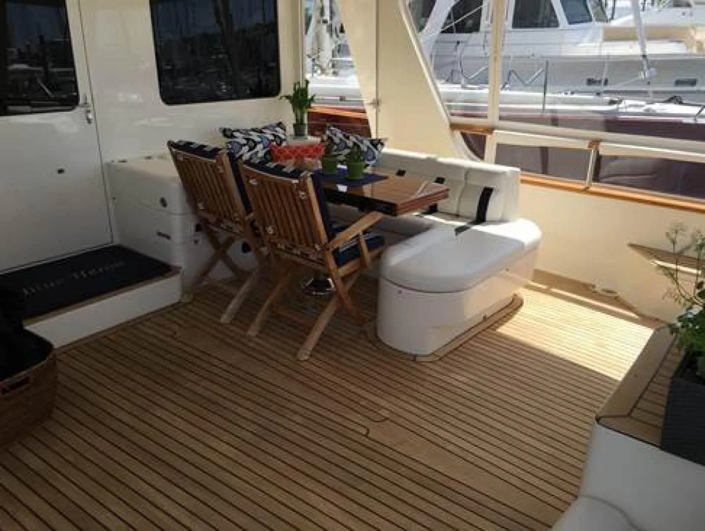 a room with a table and chairs aboard VK Yacht for Sale