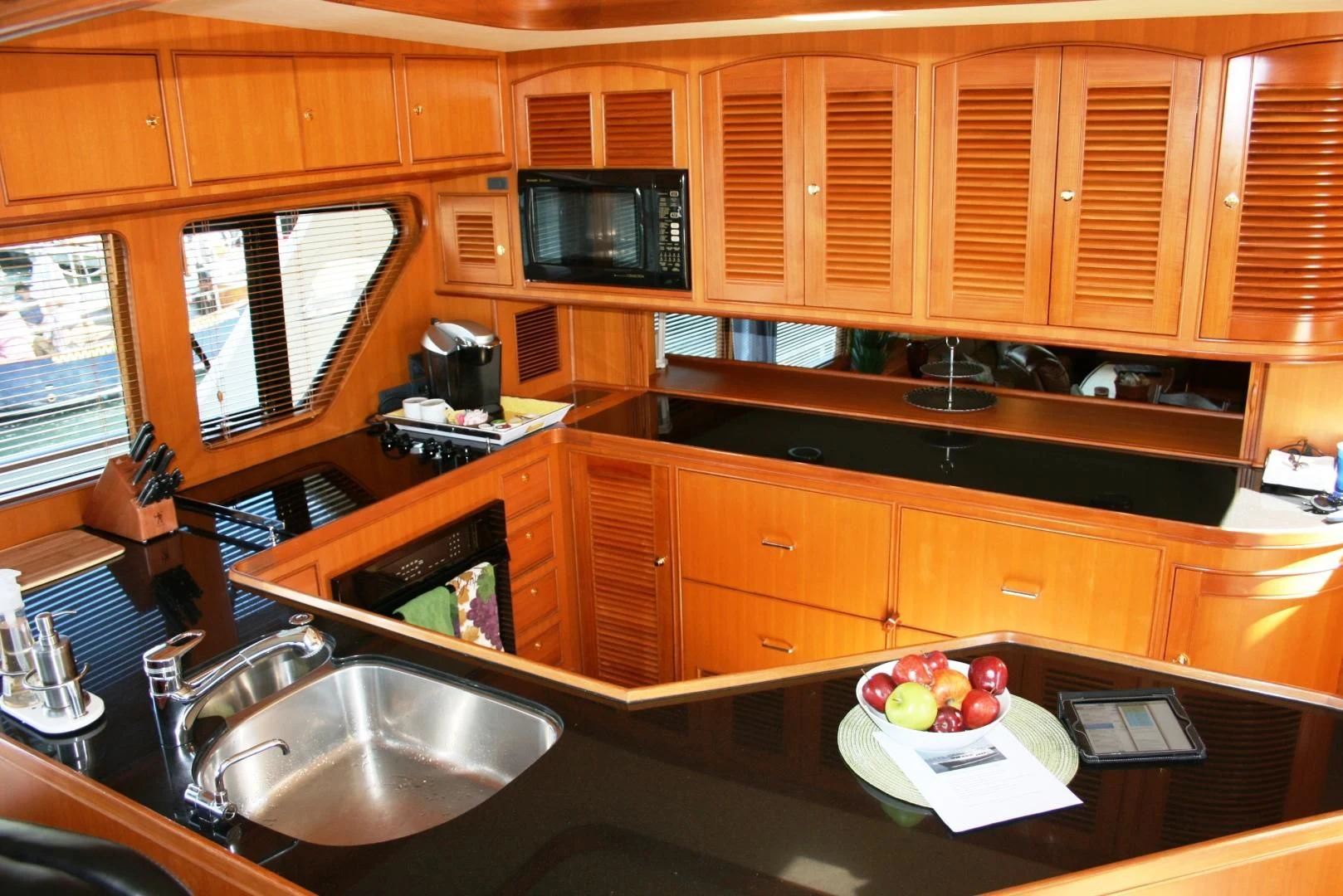 a kitchen with wooden cabinets aboard VK Yacht for Sale