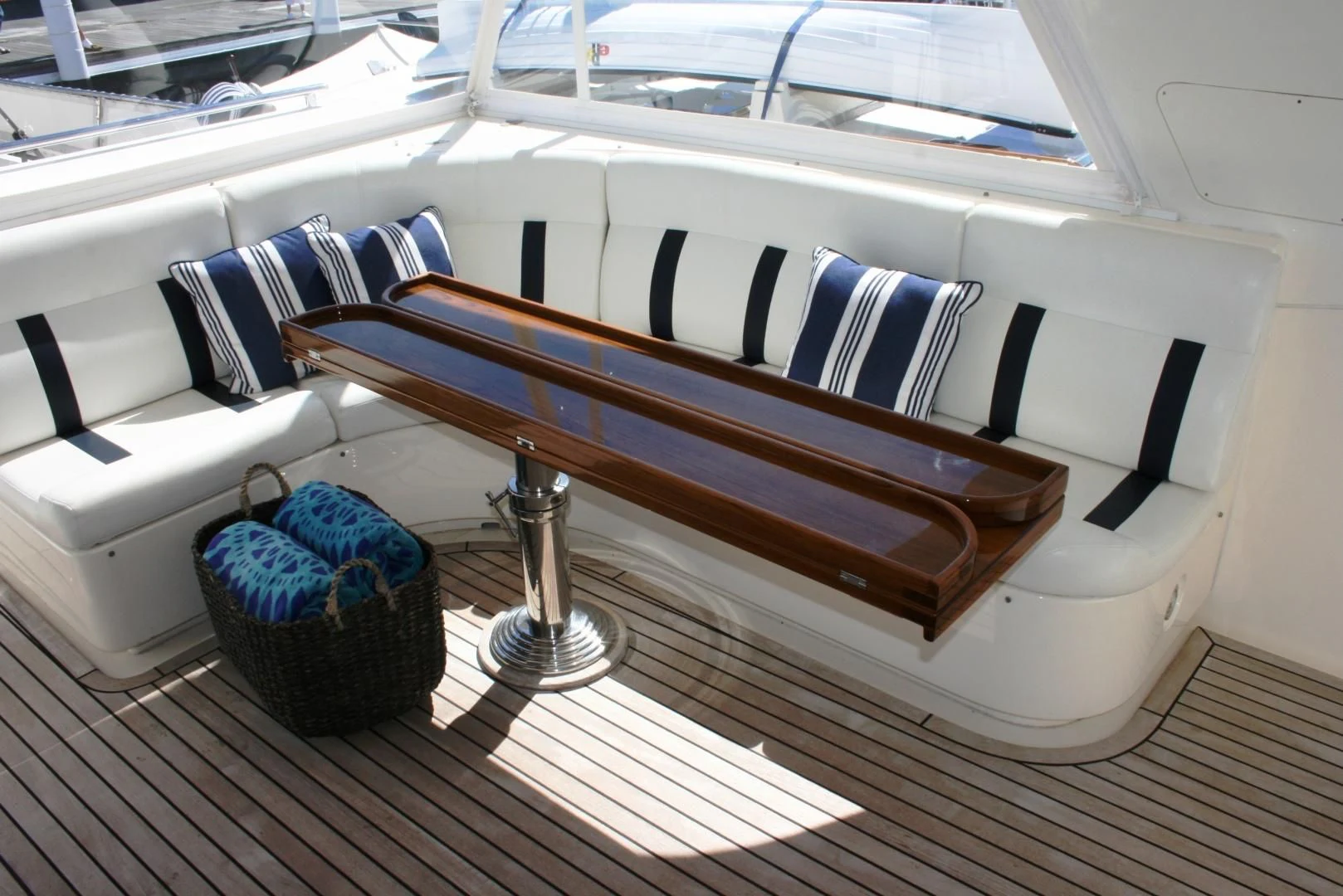 a wooden bench with a blue towel on it aboard VK Yacht for Sale