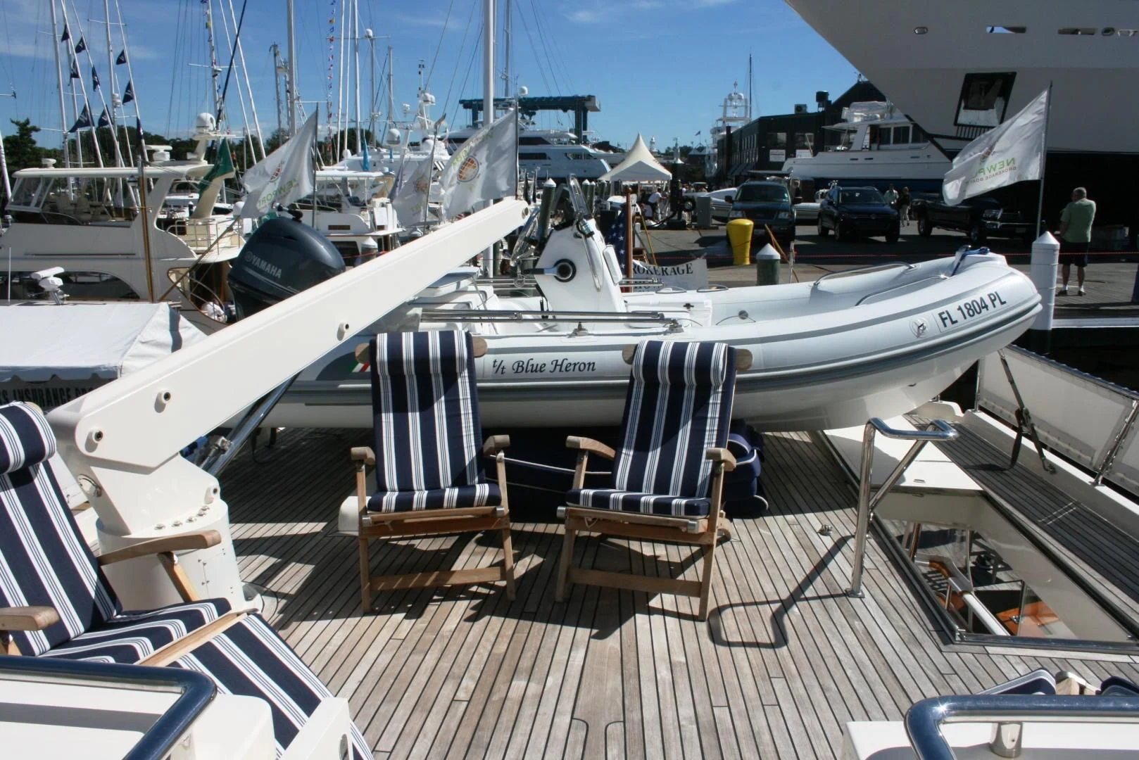 a deck with chairs and boats aboard VK Yacht for Sale
