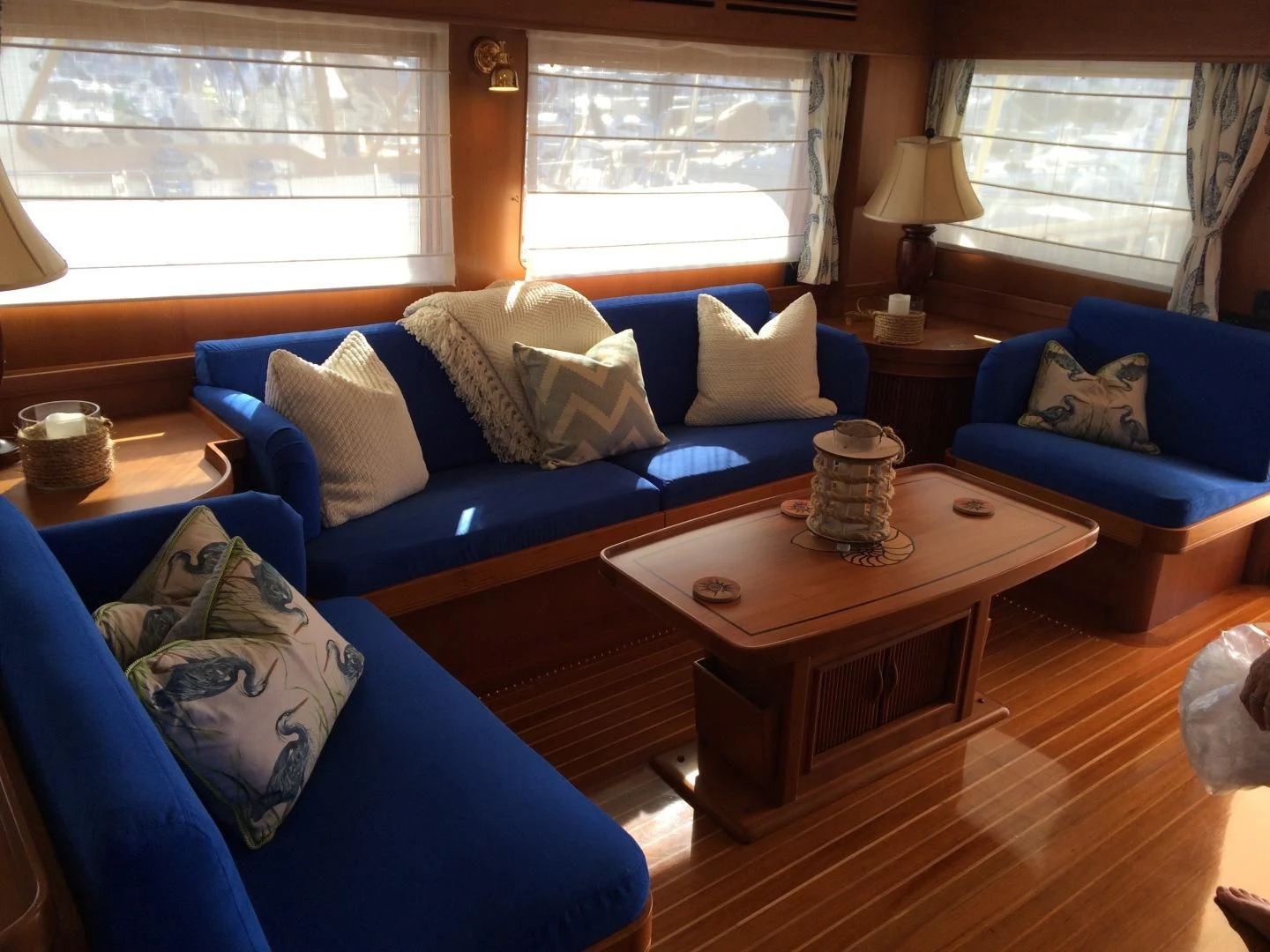 a living room with blue couches aboard VK Yacht for Sale