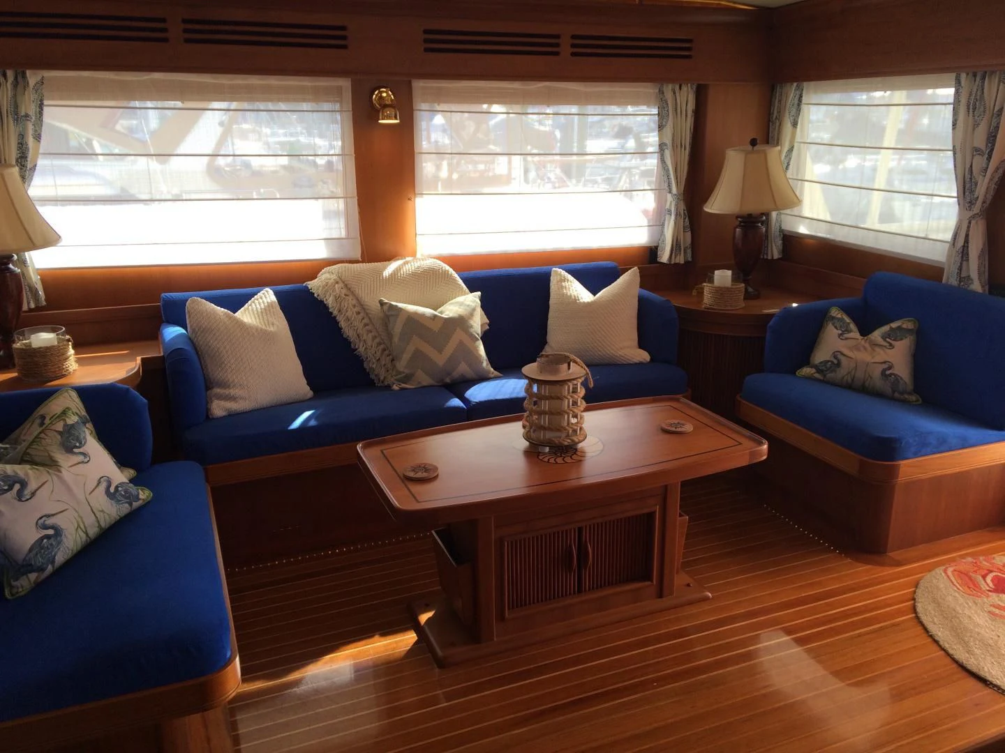a living room with a blue couch and a coffee table aboard VK Yacht for Sale