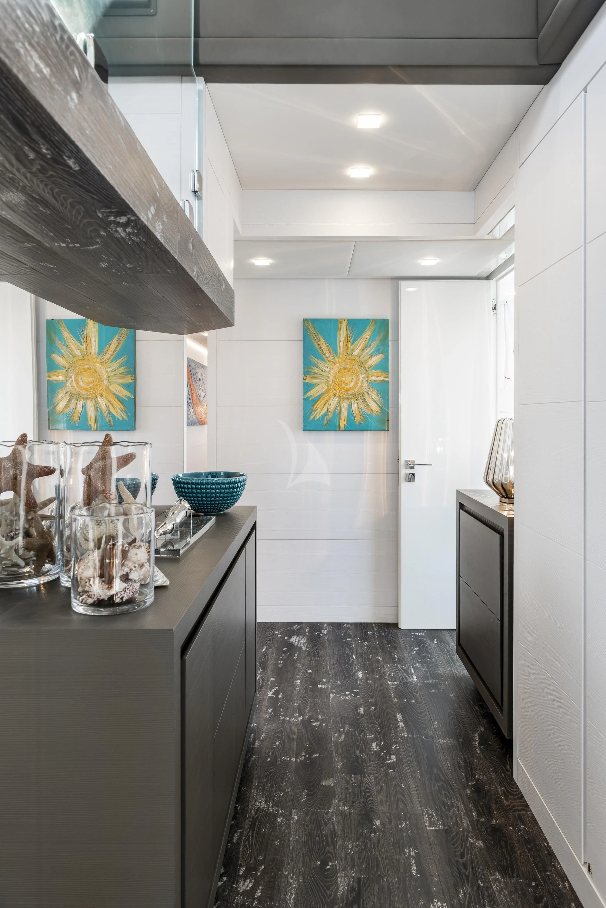 a kitchen with a black counter and black cabinets aboard SANDS Yacht for Sale