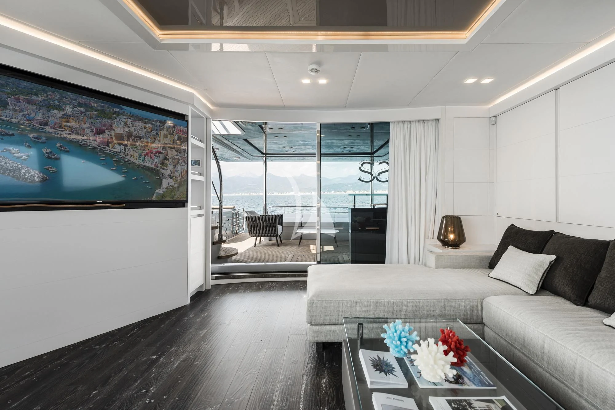 a living room with a large glass door aboard SANDS Yacht for Sale