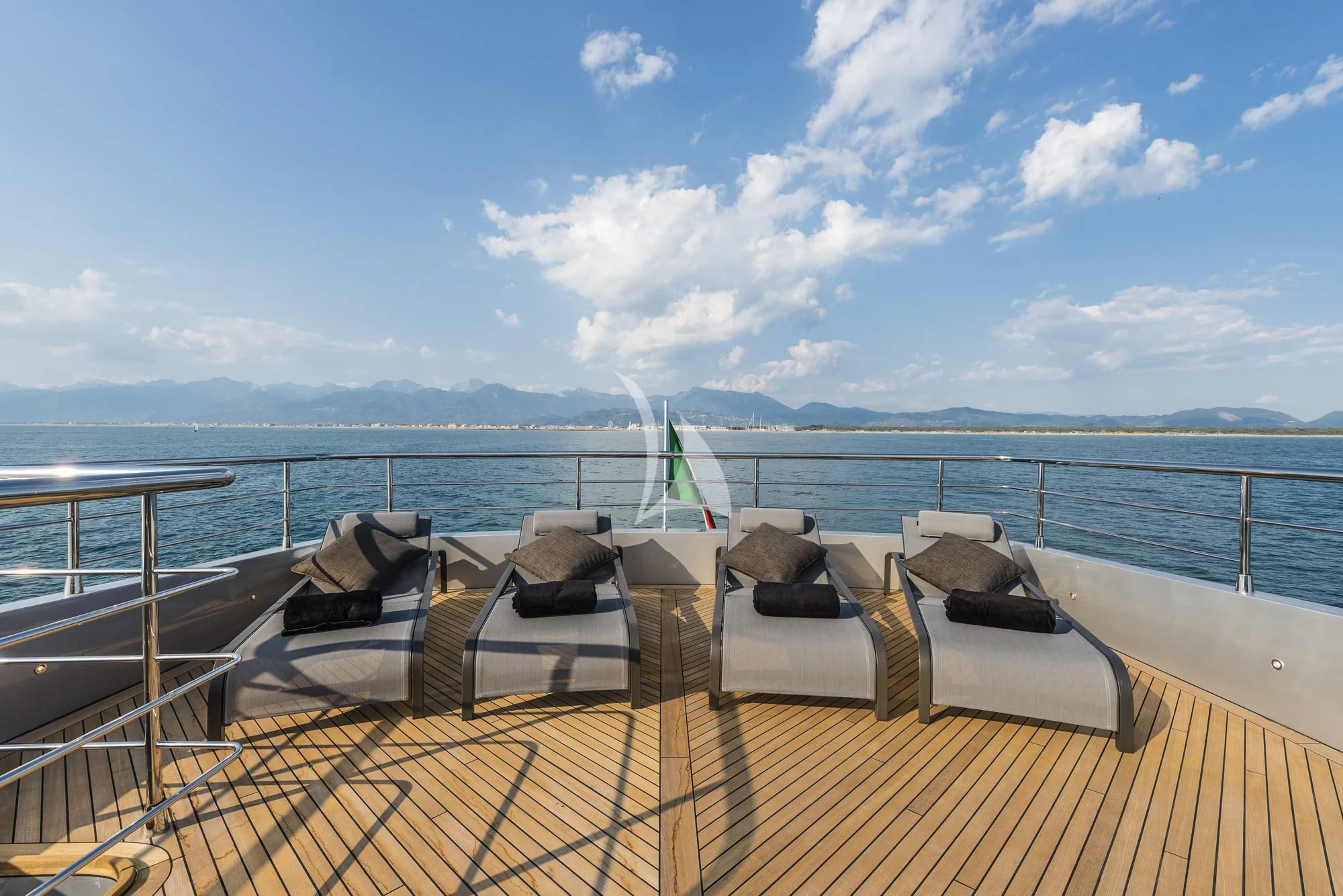 a deck with chairs on it by the water aboard SANDS Yacht for Sale