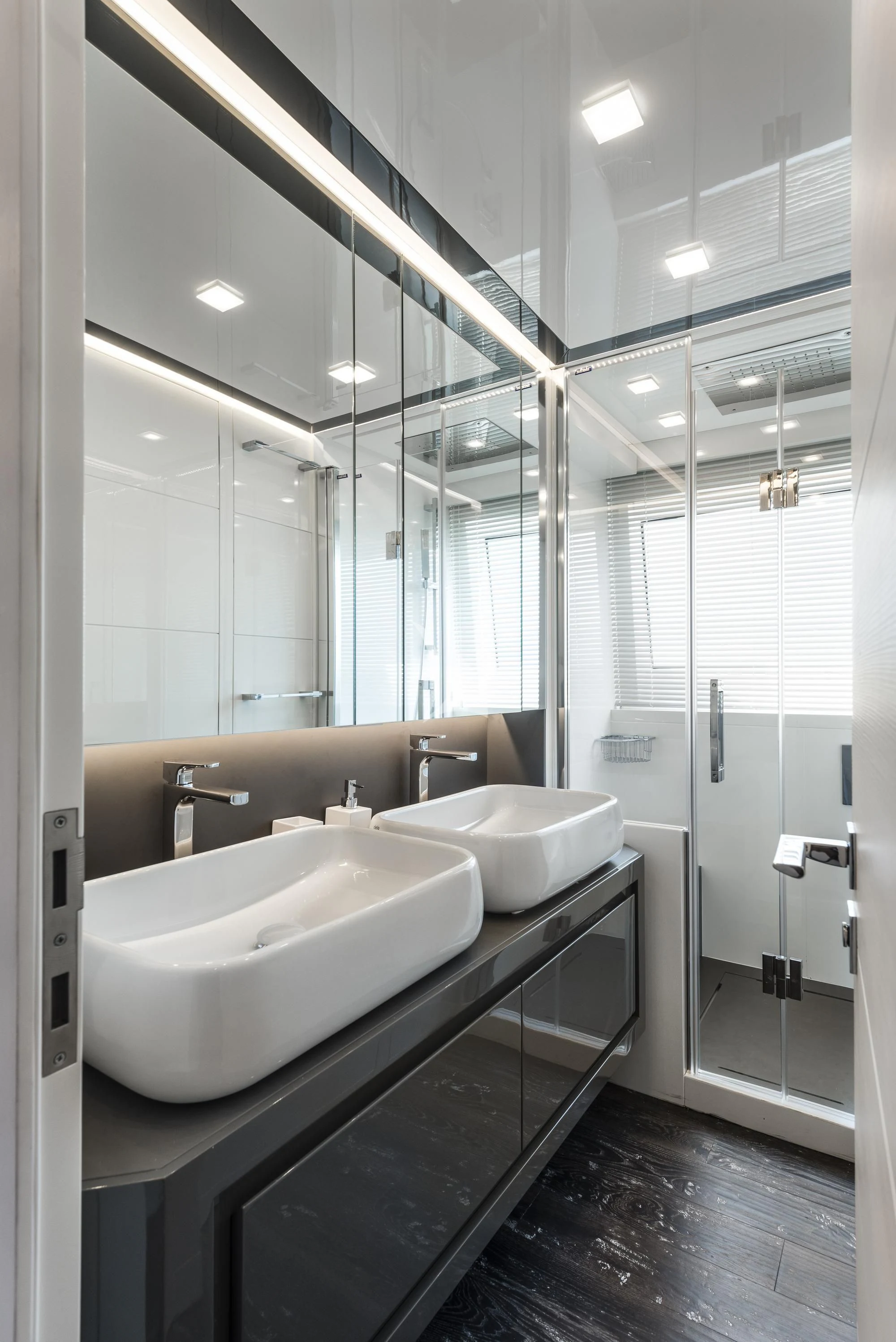 a bathroom with a large mirror aboard SANDS Yacht for Sale