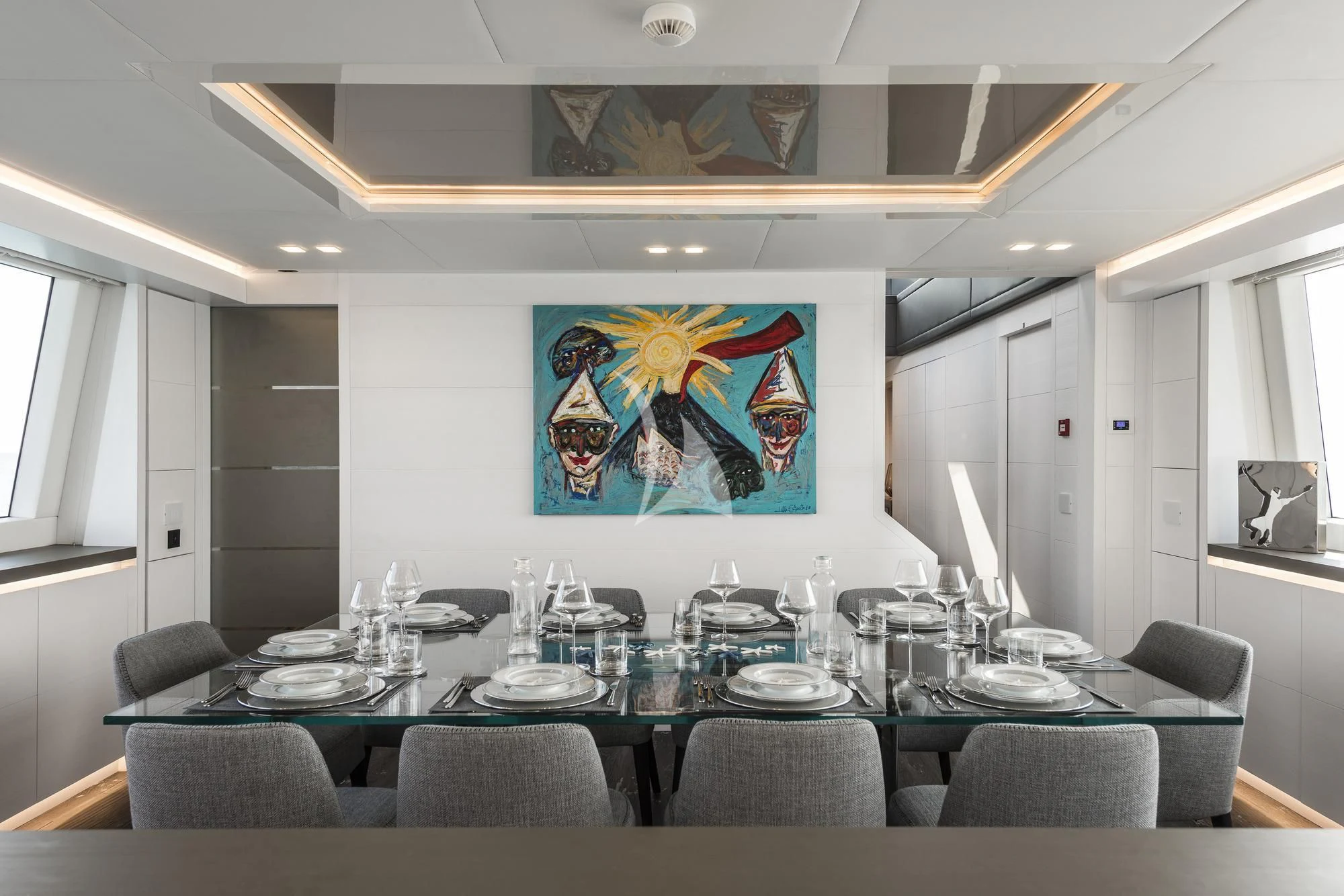 a large table with empty plates aboard SANDS Yacht for Sale