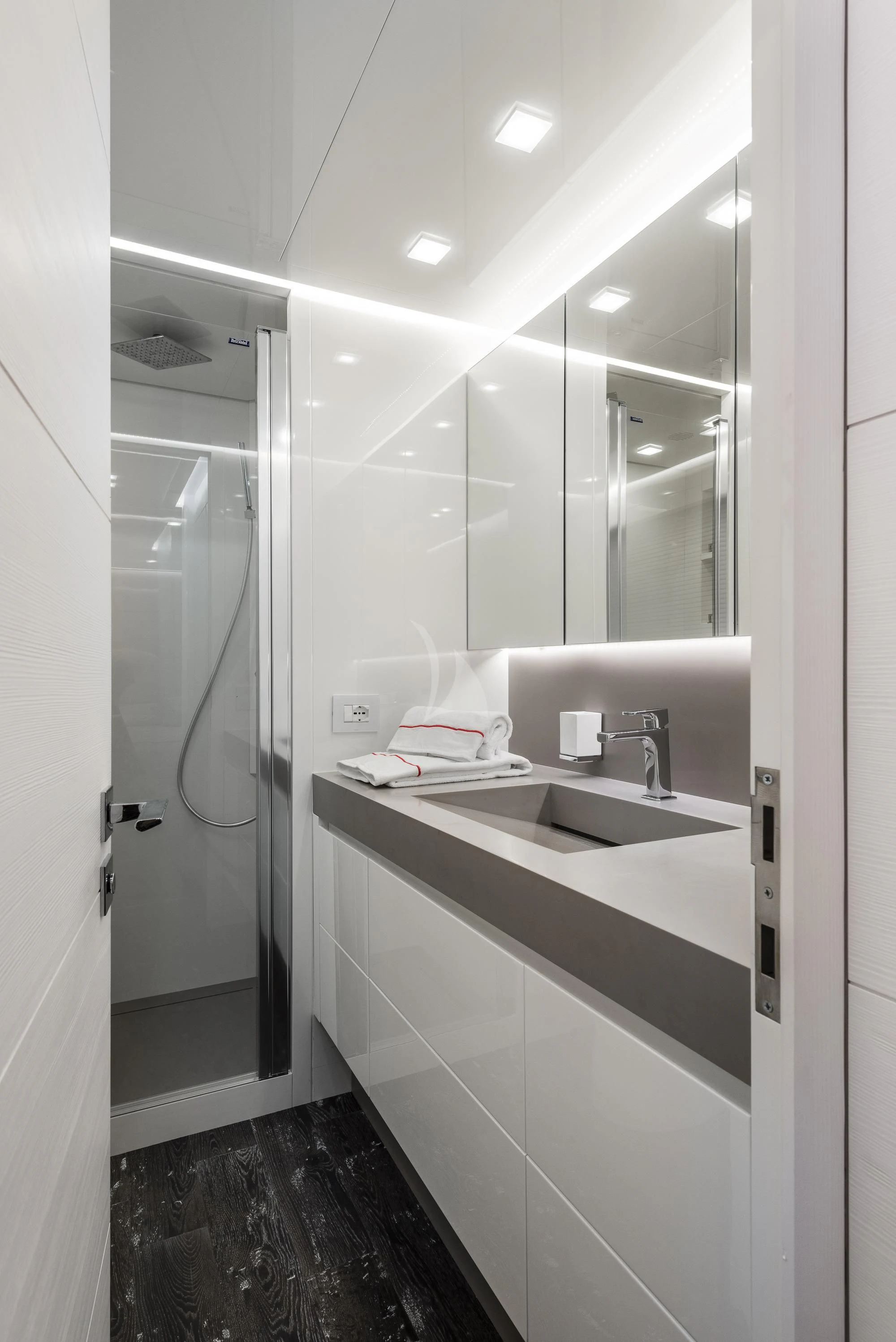 a bathroom with a glass shower aboard SANDS Yacht for Sale