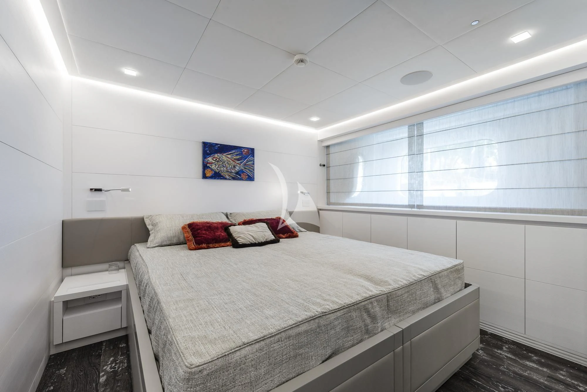 a bedroom with a bed and a window aboard SANDS Yacht for Sale