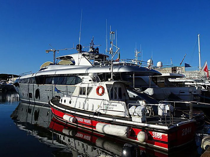 a boat docked at a pier aboard SANDS Yacht for Sale