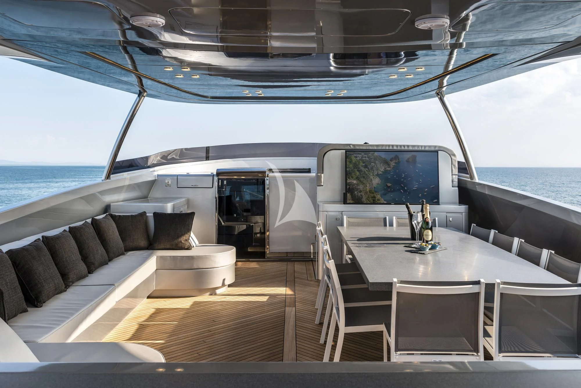 a boat with a table and chairs aboard SANDS Yacht for Sale