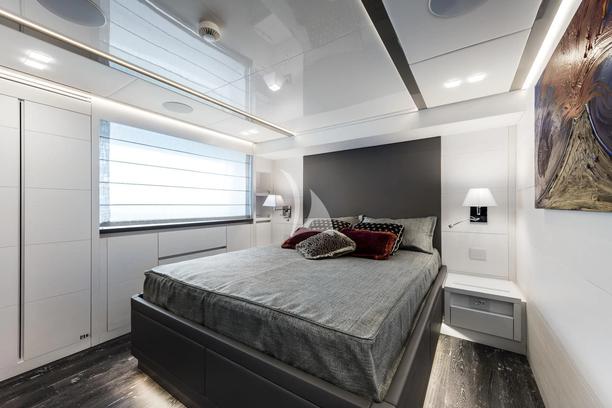 a bedroom with a bed and a lamp aboard SANDS Yacht for Sale