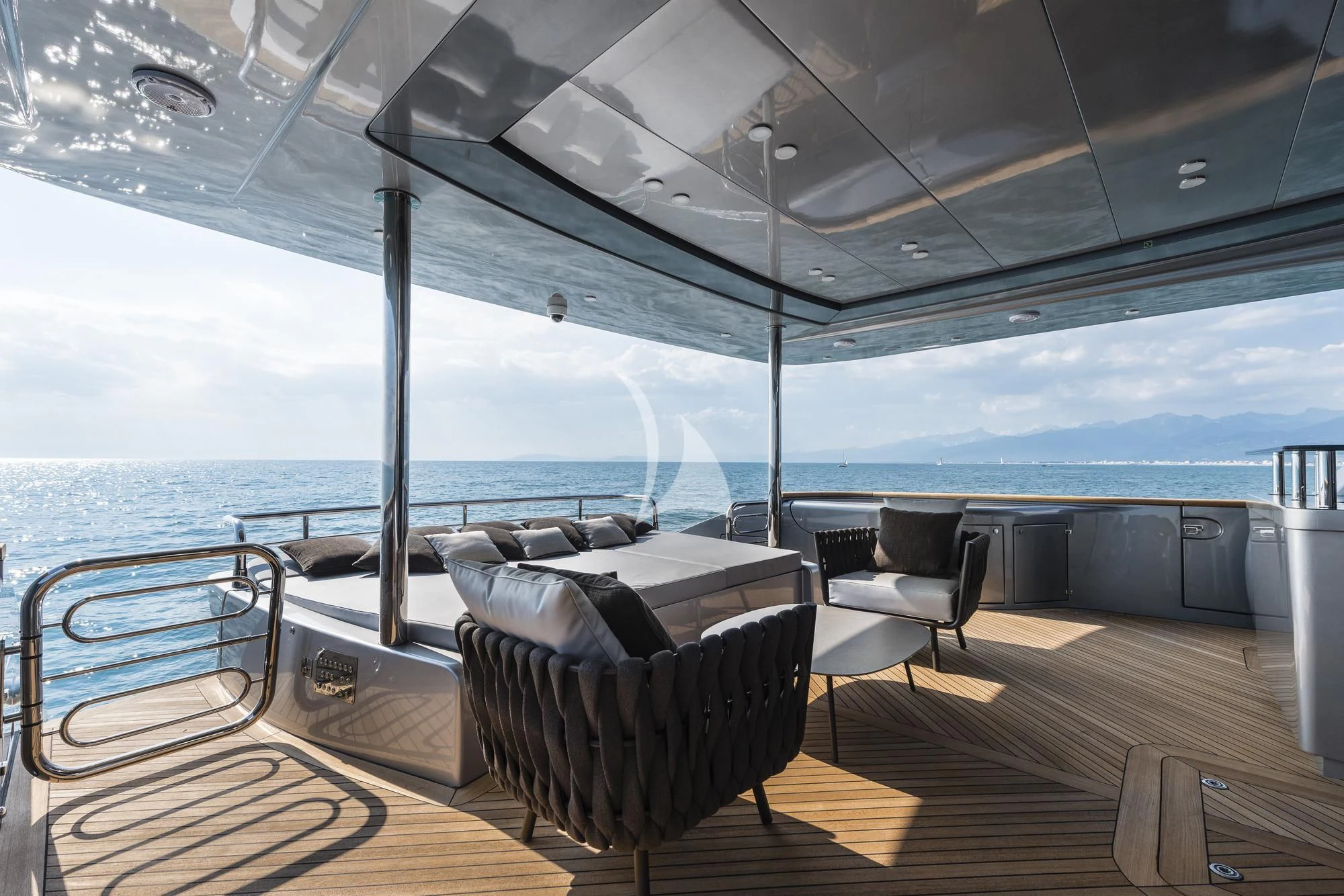a deck with chairs and a table on it aboard SANDS Yacht for Sale