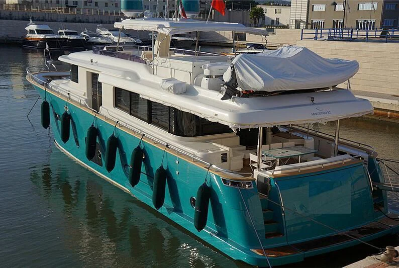 a boat docked at a pier aboard SANGRIA Yacht for Sale
