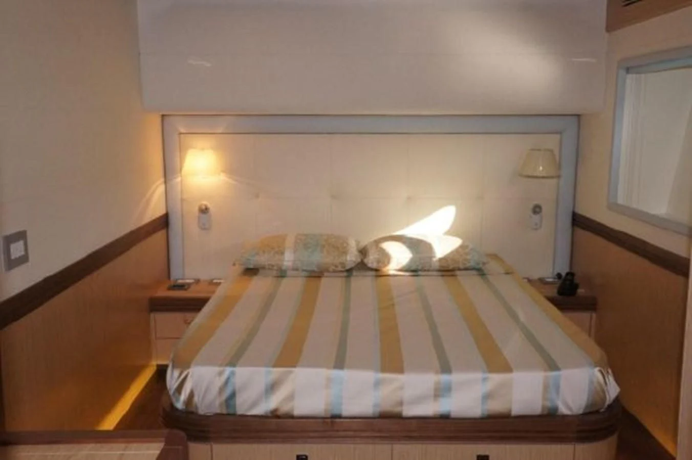 a bed with a striped blanket aboard SANGRIA Yacht for Sale