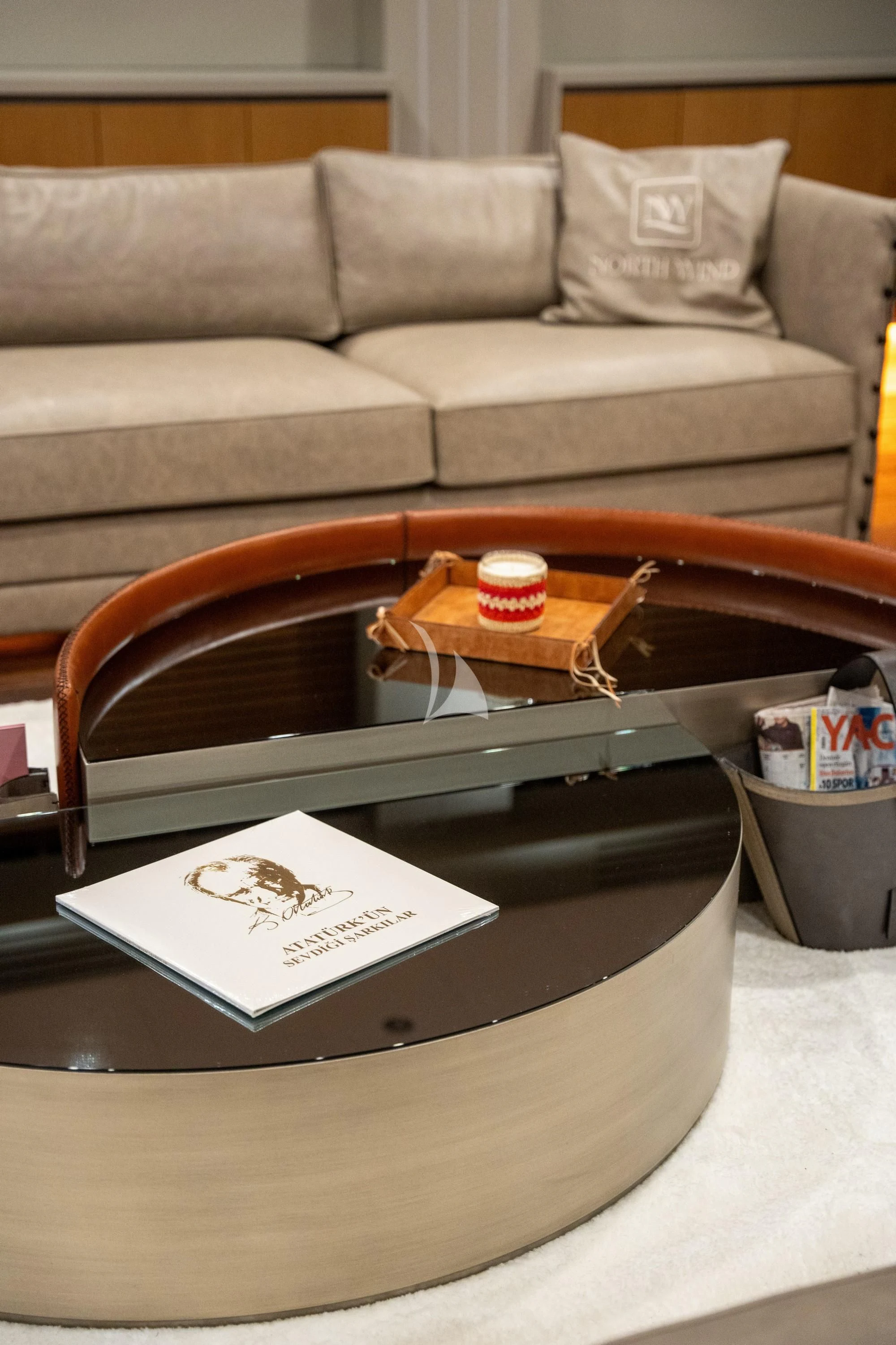 a coffee table with a box and a coffee cup on it aboard NORTH WIND Yacht for Sale