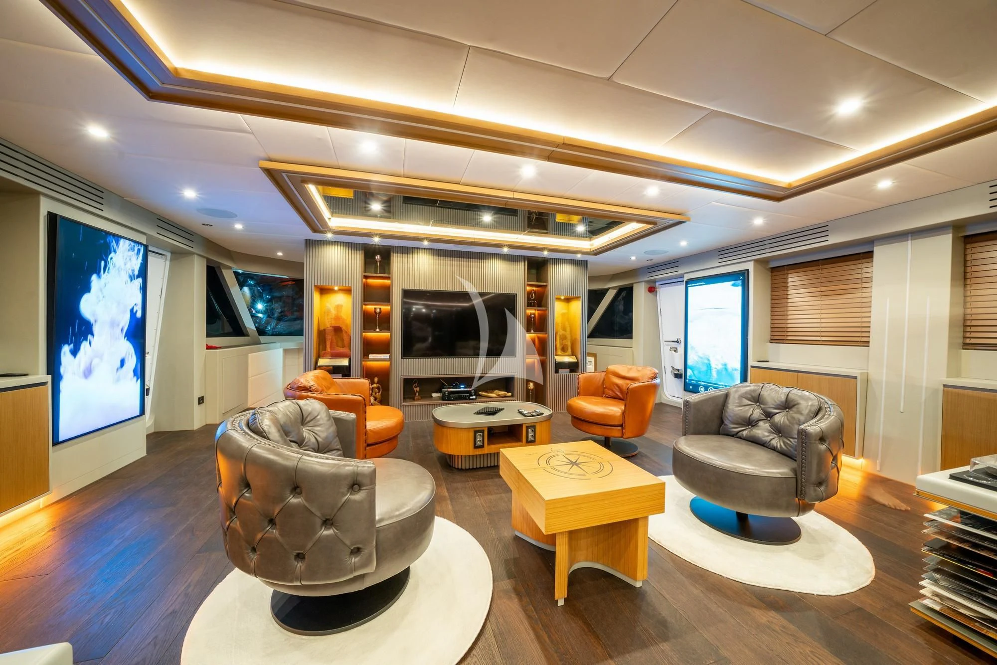 a living room with a large screen aboard NORTH WIND Yacht for Sale