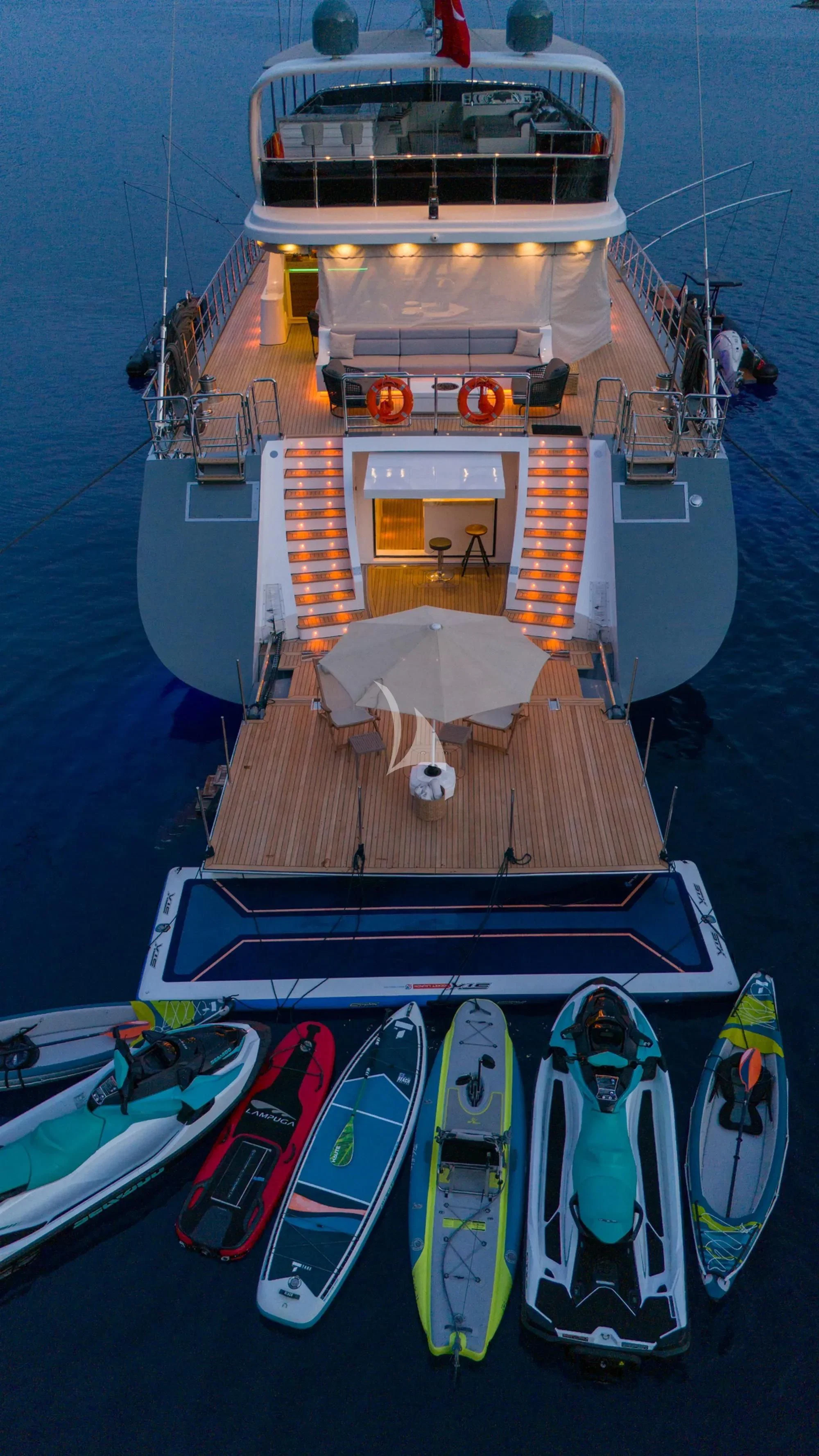 a boat with a deck and a deck and a table with chairs aboard NORTH WIND Yacht for Sale