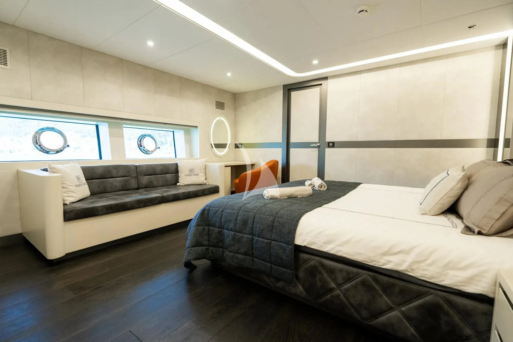 a bedroom with a bed and a couch aboard NORTH WIND Yacht for Sale