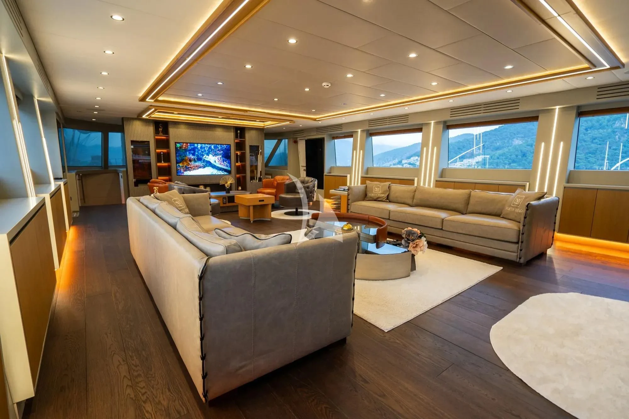 a living room with a large screen aboard NORTH WIND Yacht for Sale