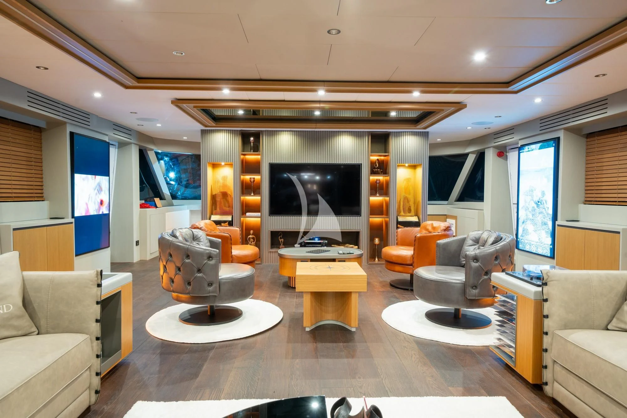 a living room with a large screen aboard NORTH WIND Yacht for Sale