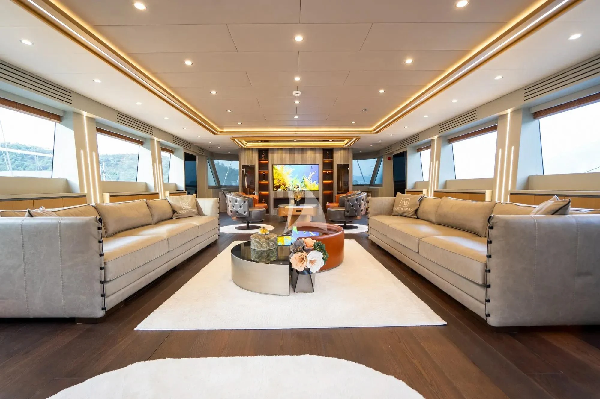 a living room with a couch and a coffee table aboard NORTH WIND Yacht for Sale