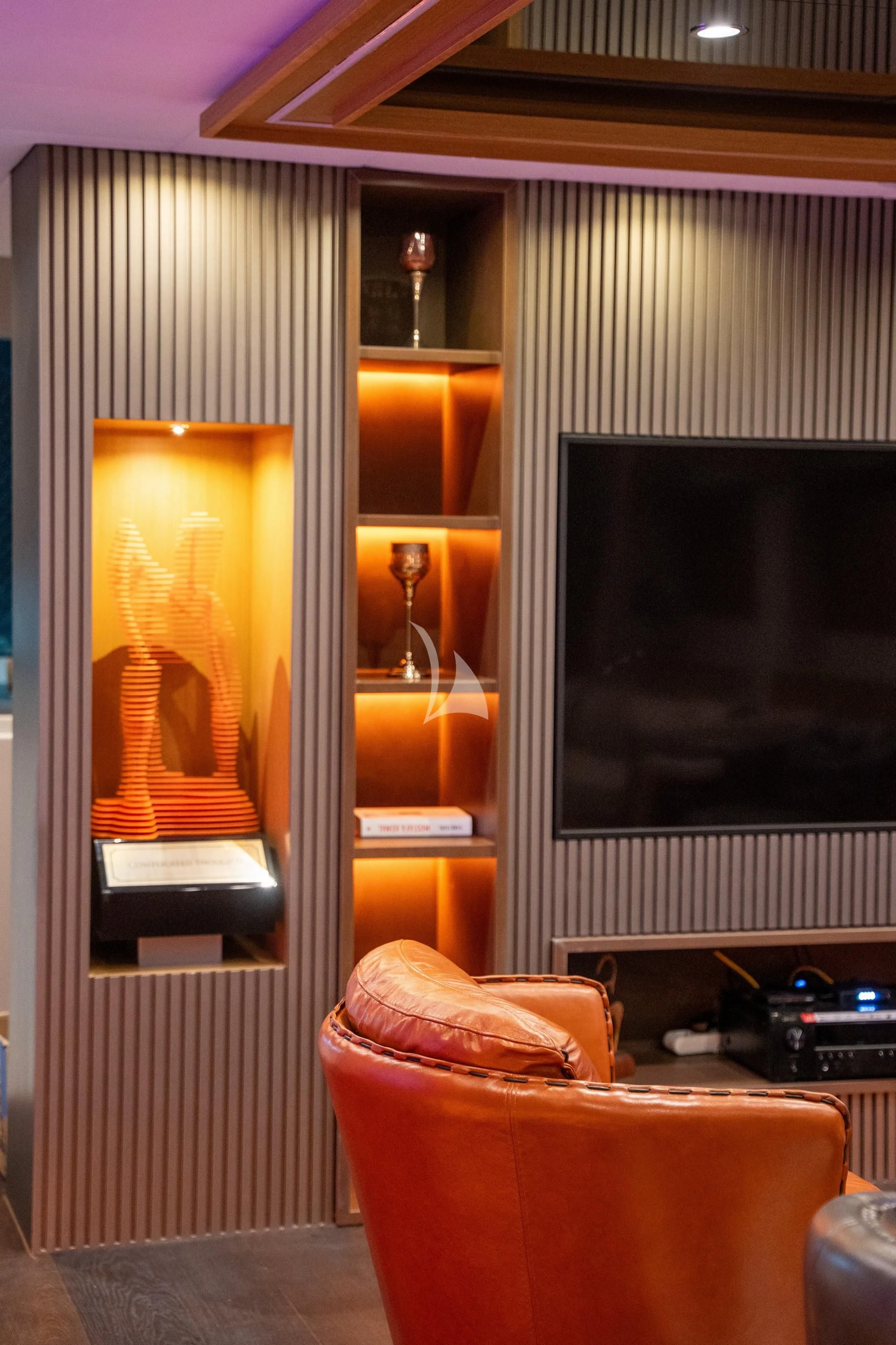a room with a couch and a television aboard NORTH WIND Yacht for Sale