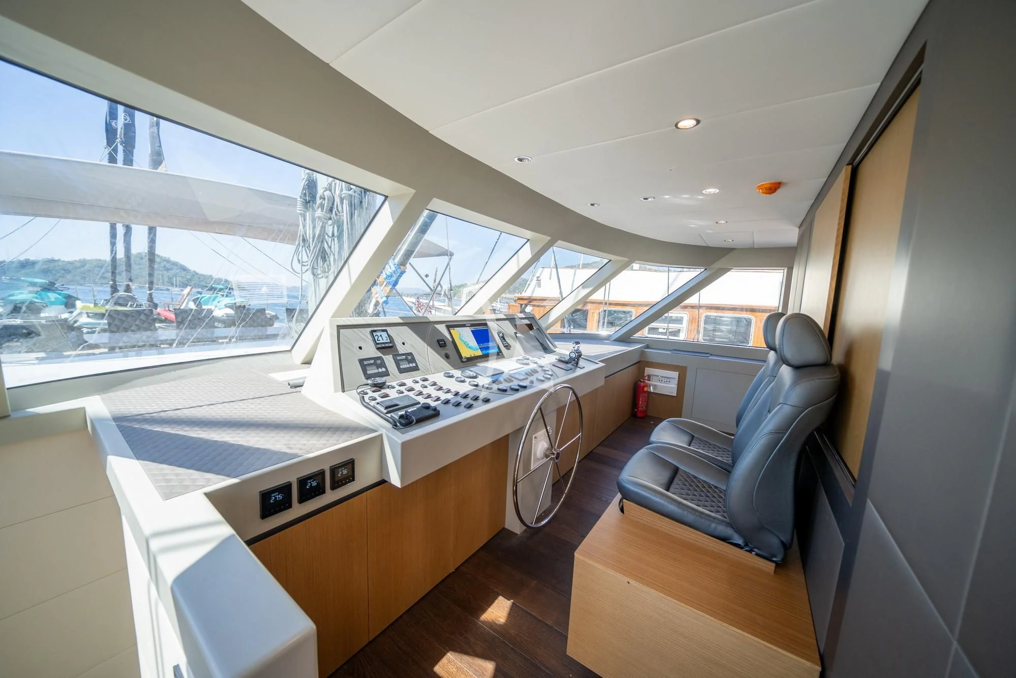 a room with a large window and a desk with a computer on it aboard NORTH WIND Yacht for Sale