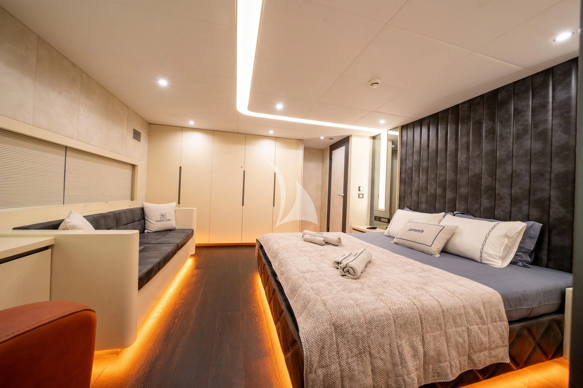 a bedroom with a bed and a desk aboard NORTH WIND Yacht for Sale