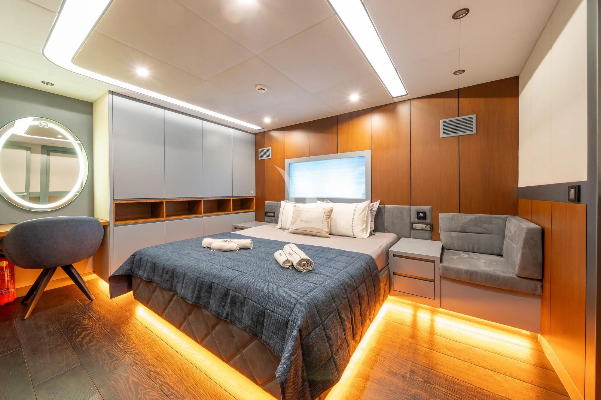 a bedroom with a bed and a couch aboard NORTH WIND Yacht for Sale