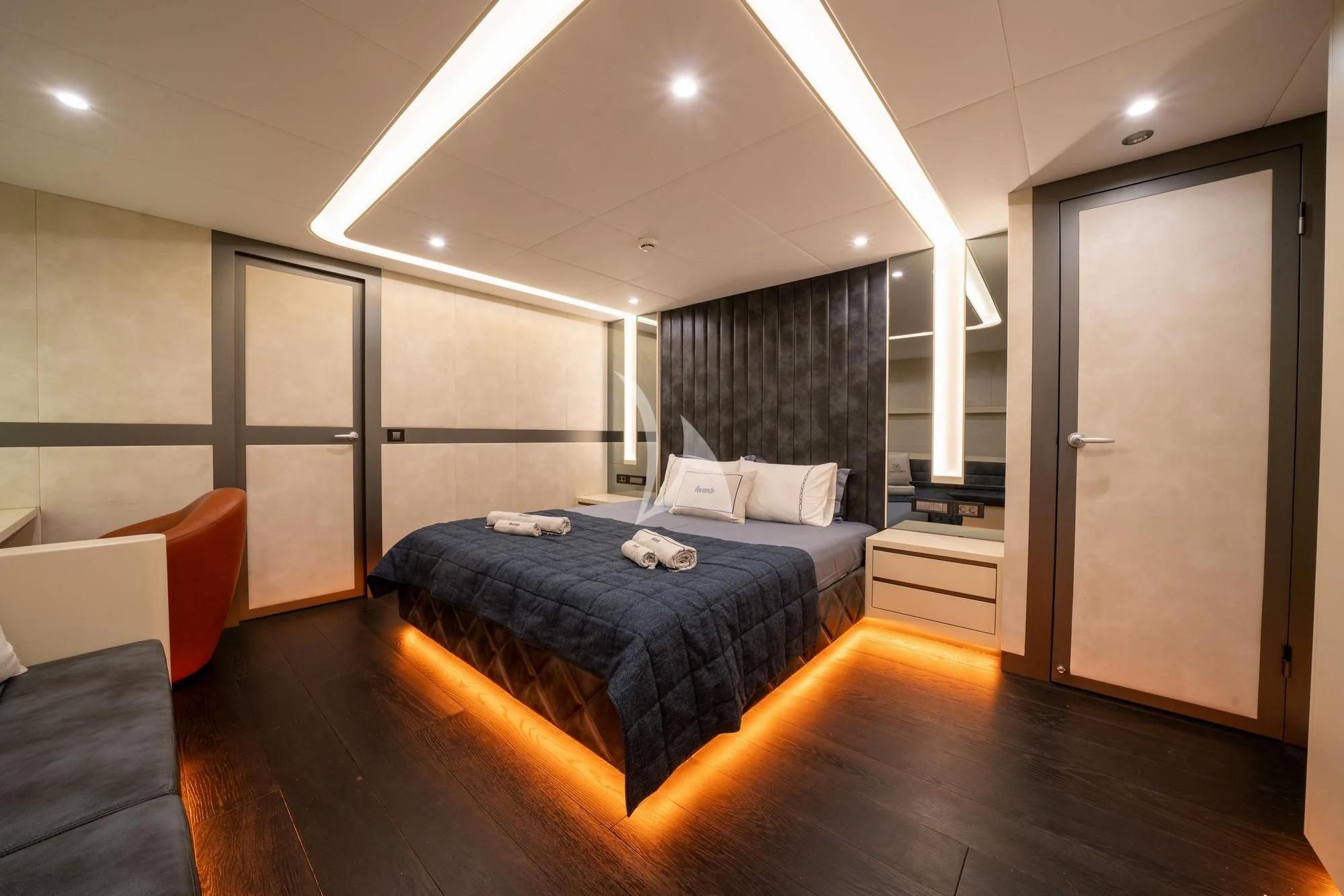 a bedroom with a bed and a chair aboard NORTH WIND Yacht for Sale