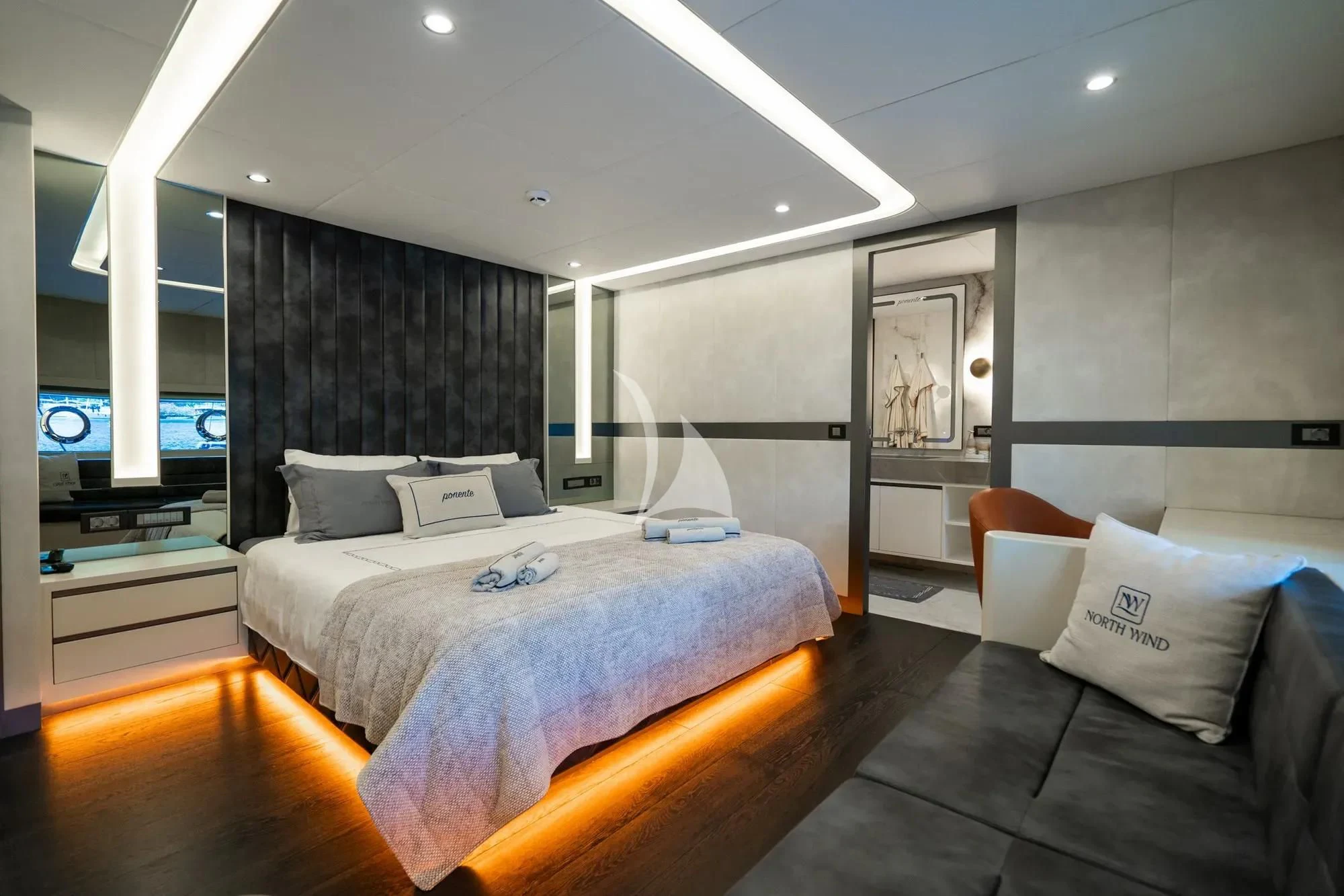 a bedroom with a bed and a couch aboard NORTH WIND Yacht for Sale