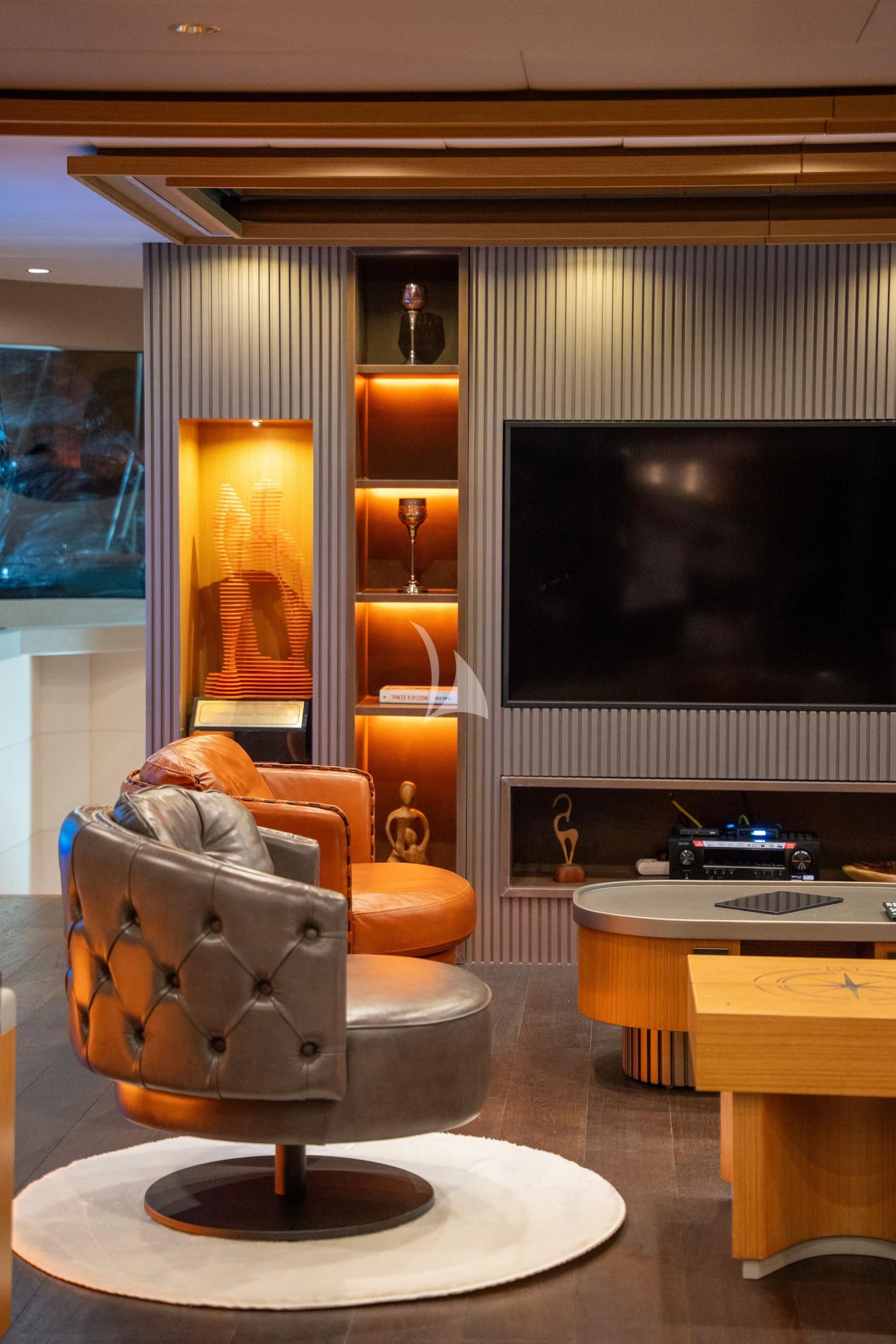 a living room with a large screen aboard NORTH WIND Yacht for Sale