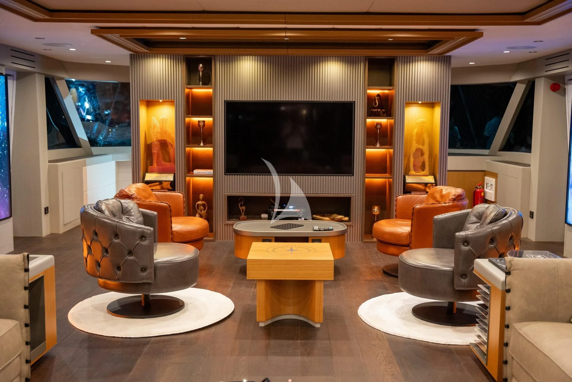 a living room with a large screen aboard NORTH WIND Yacht for Sale