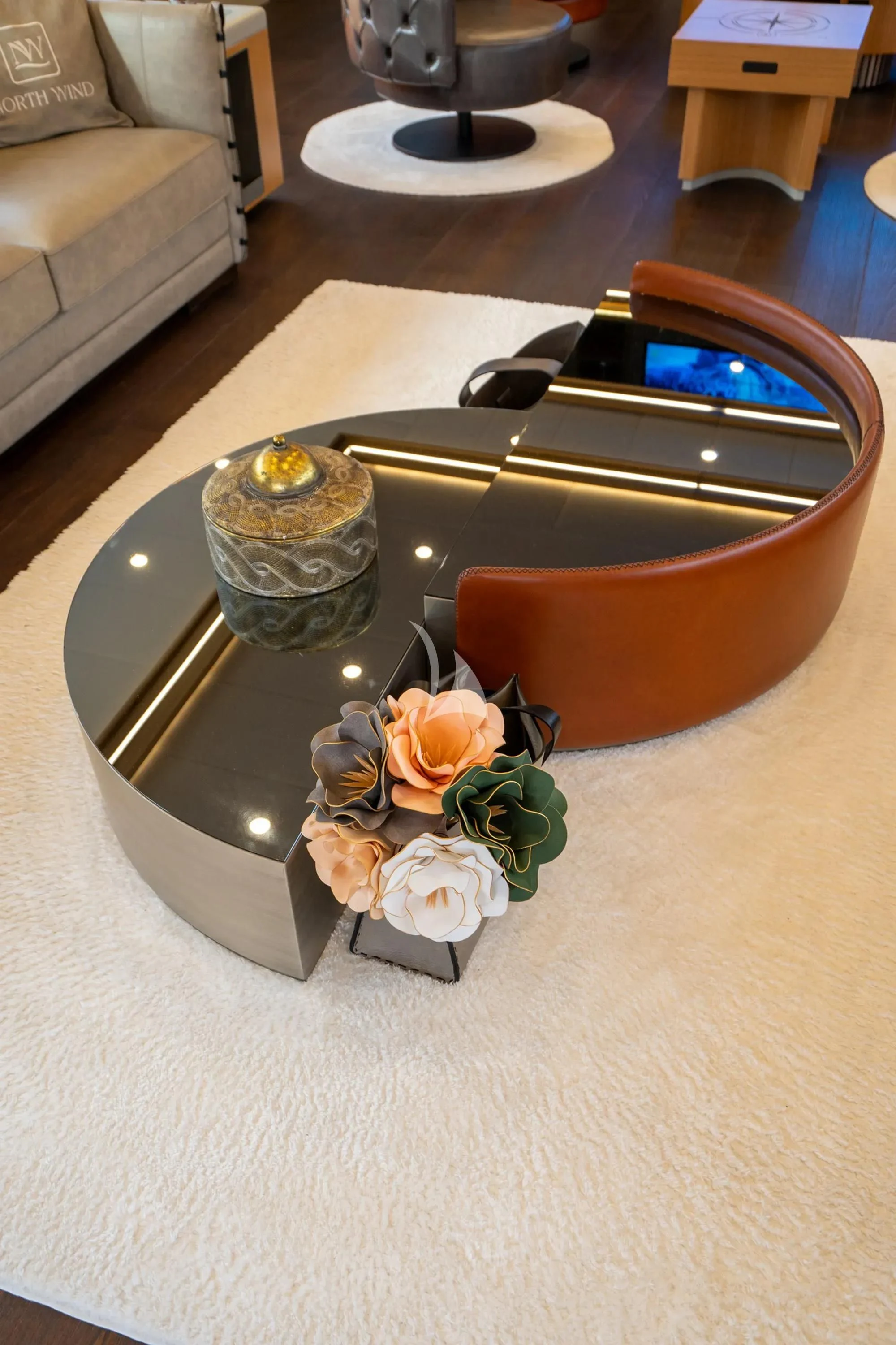 a gold and silver lighter on a table with a flower and a candle aboard NORTH WIND Yacht for Sale