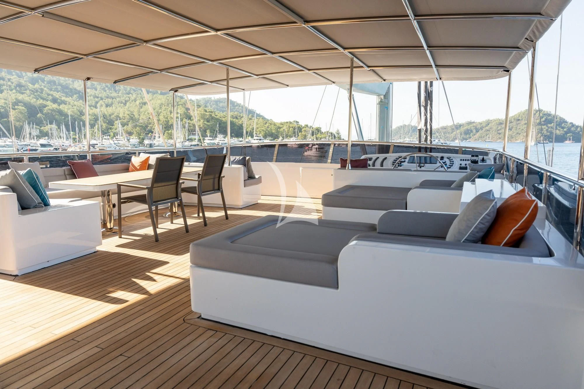 a large lounge area with a large deck and a large deck with a view of the water and aboard NORTH WIND Yacht for Sale