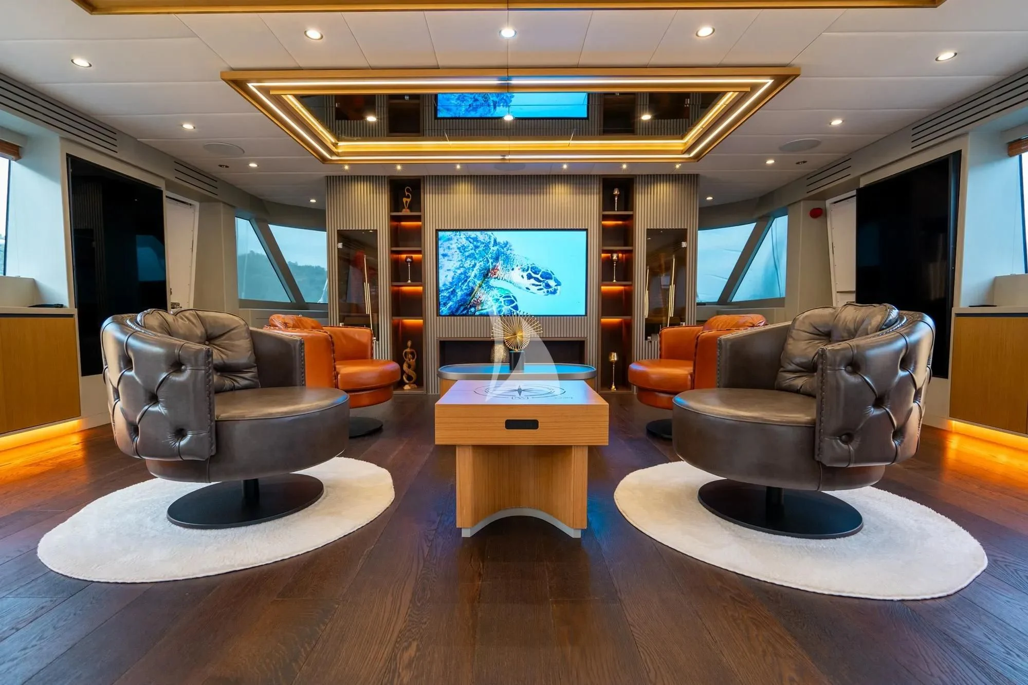 a living room with a large screen aboard NORTH WIND Yacht for Sale