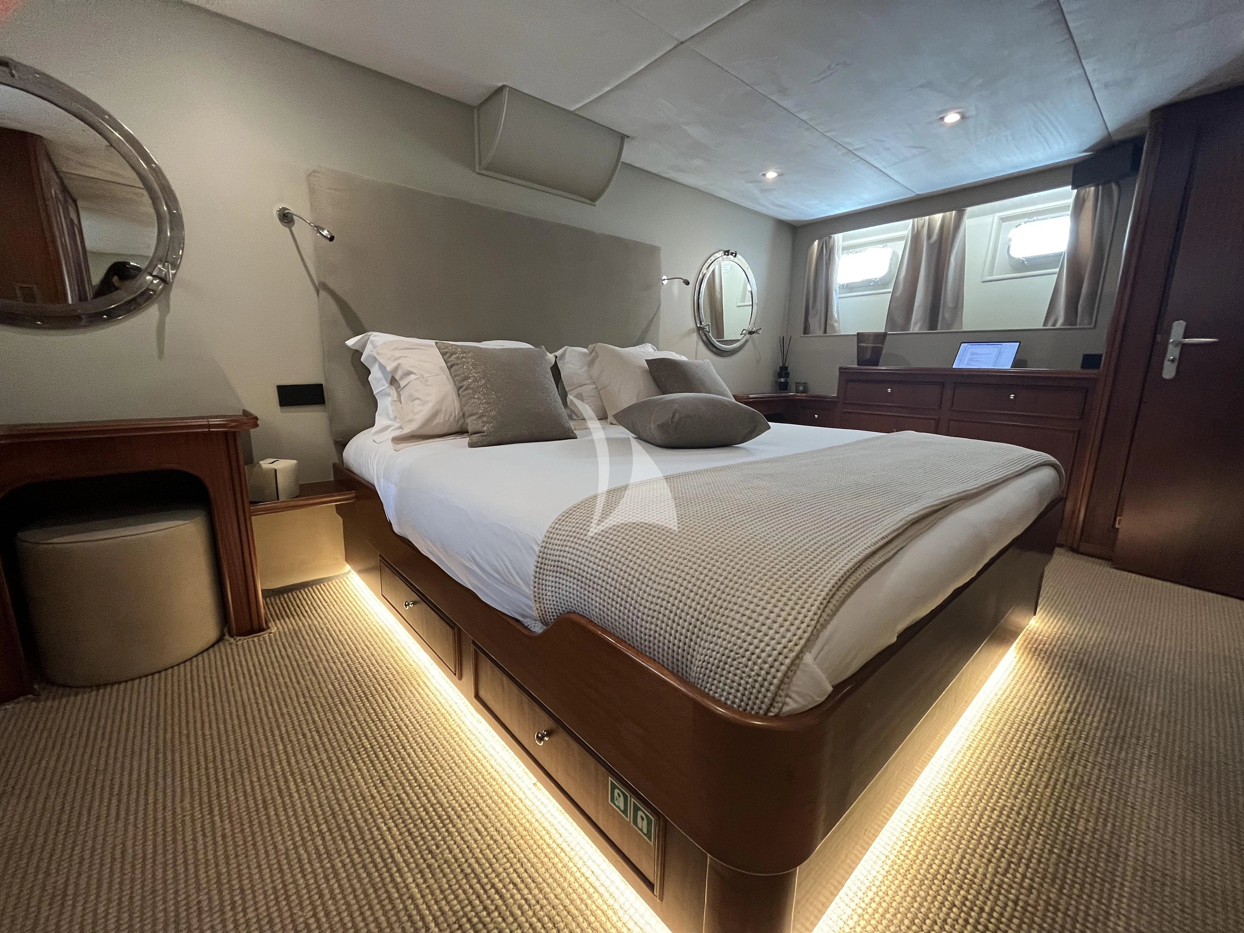 a bedroom with a bed and a desk aboard STALCA Yacht for Sale