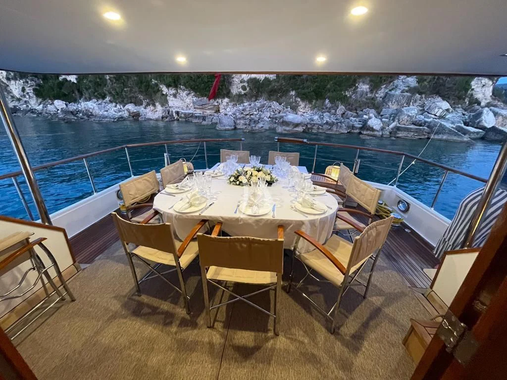 a room with a table and chairs aboard STALCA Yacht for Sale