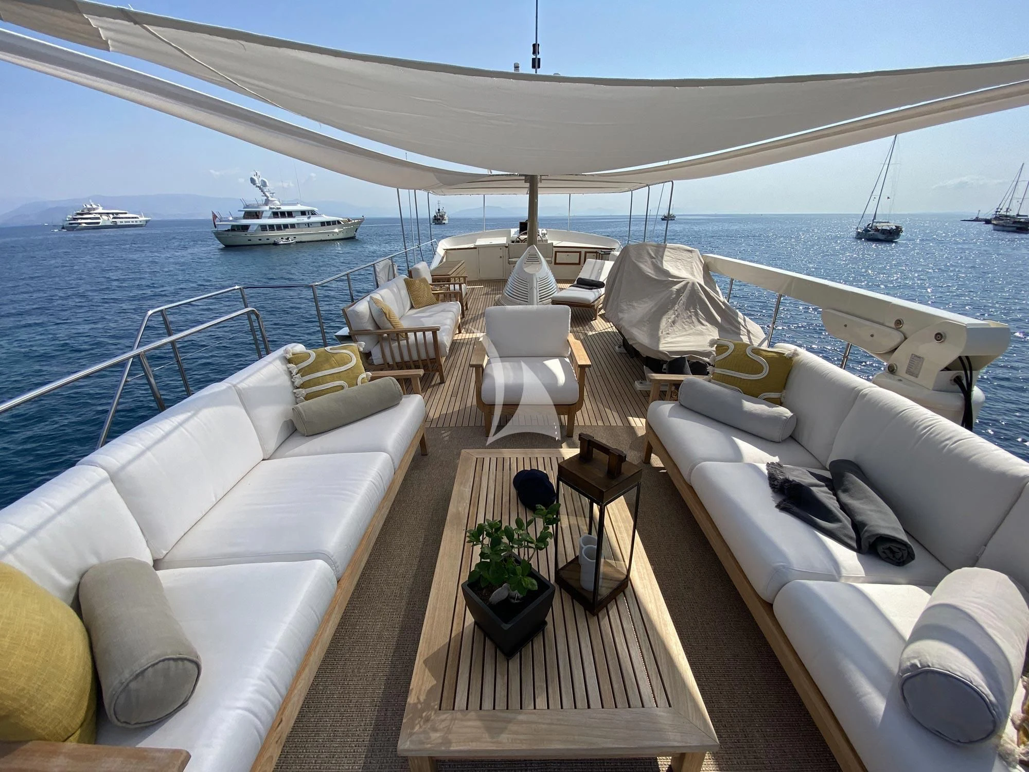 a boat dock with chairs and tables aboard STALCA Yacht for Sale