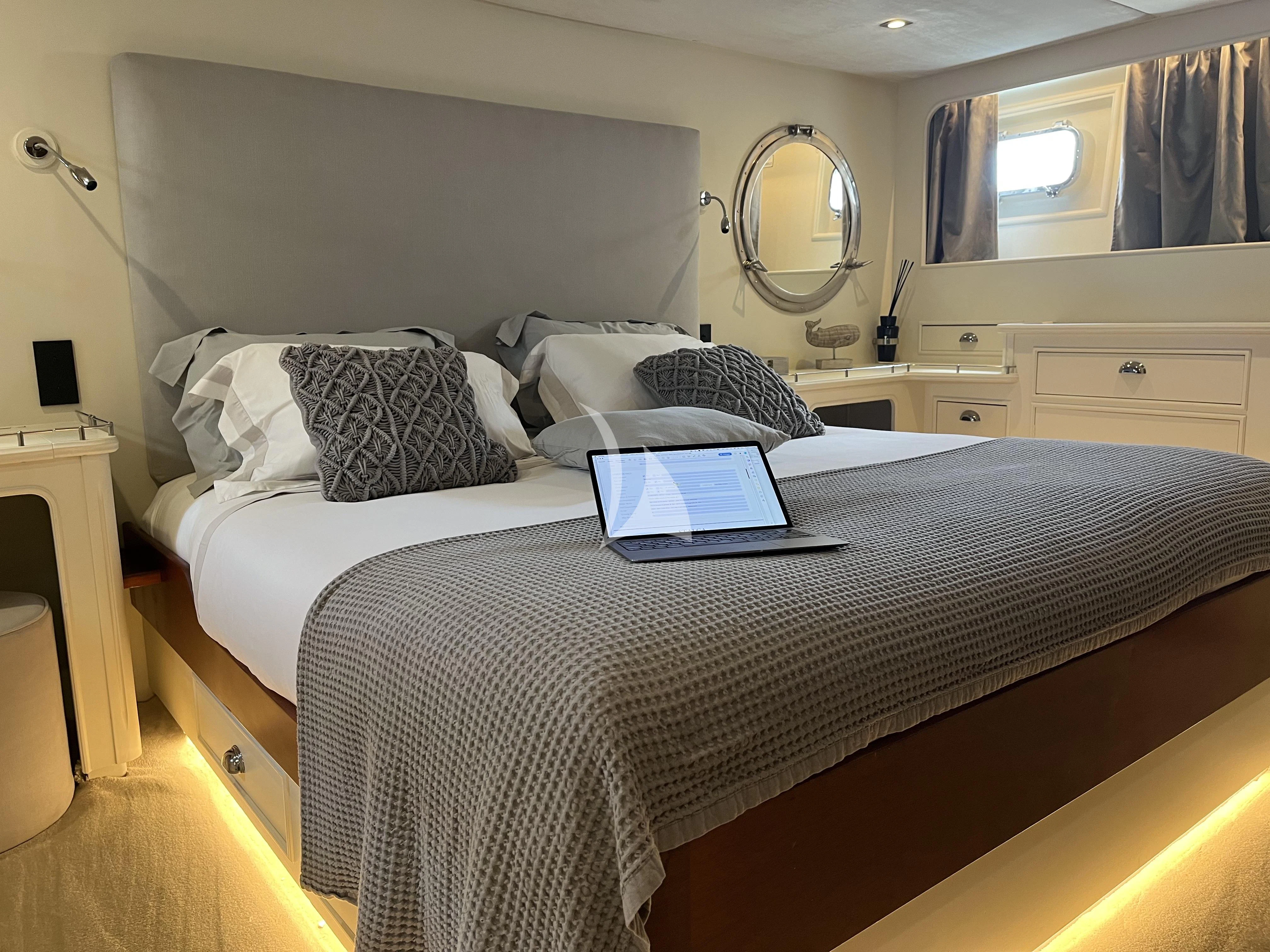 a bed with a laptop on it aboard STALCA Yacht for Sale
